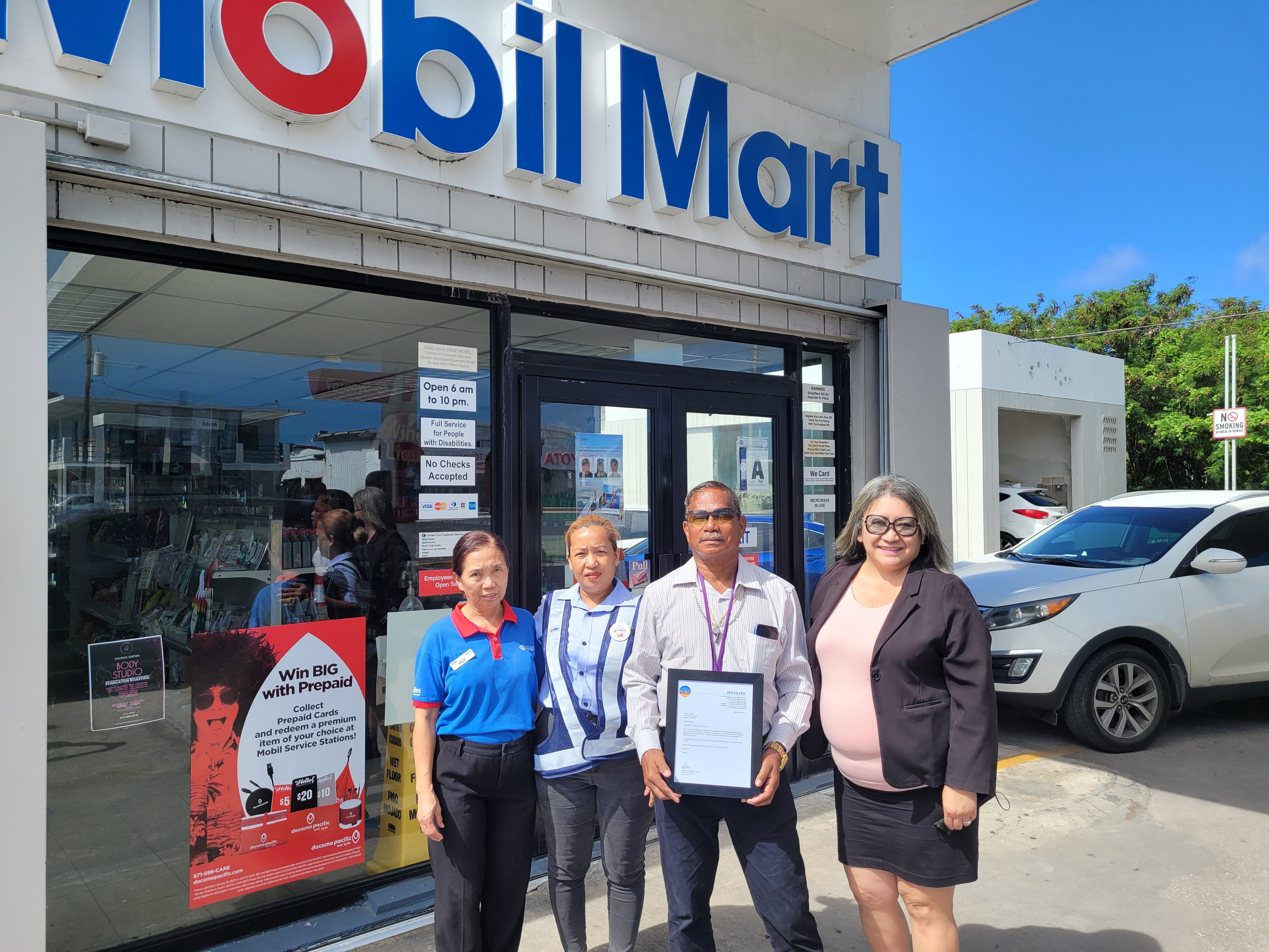 Community volunteer Max Aguon, 2nd right, with Senate President Edith Deleon Guerrero, right, San Jose CMG Mobil station manager Emily Villagomez and a staff member on Monday morning.
