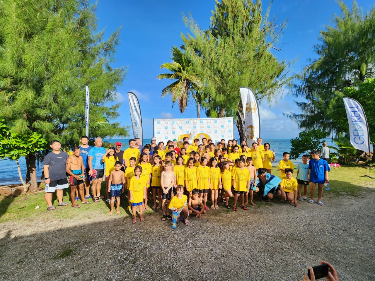 Young swimmers pose for a photo during the awards ceremony of the  Tan Holdings 50th Anniversary Ocean Swim  at the Guma Sakman on Saturday.