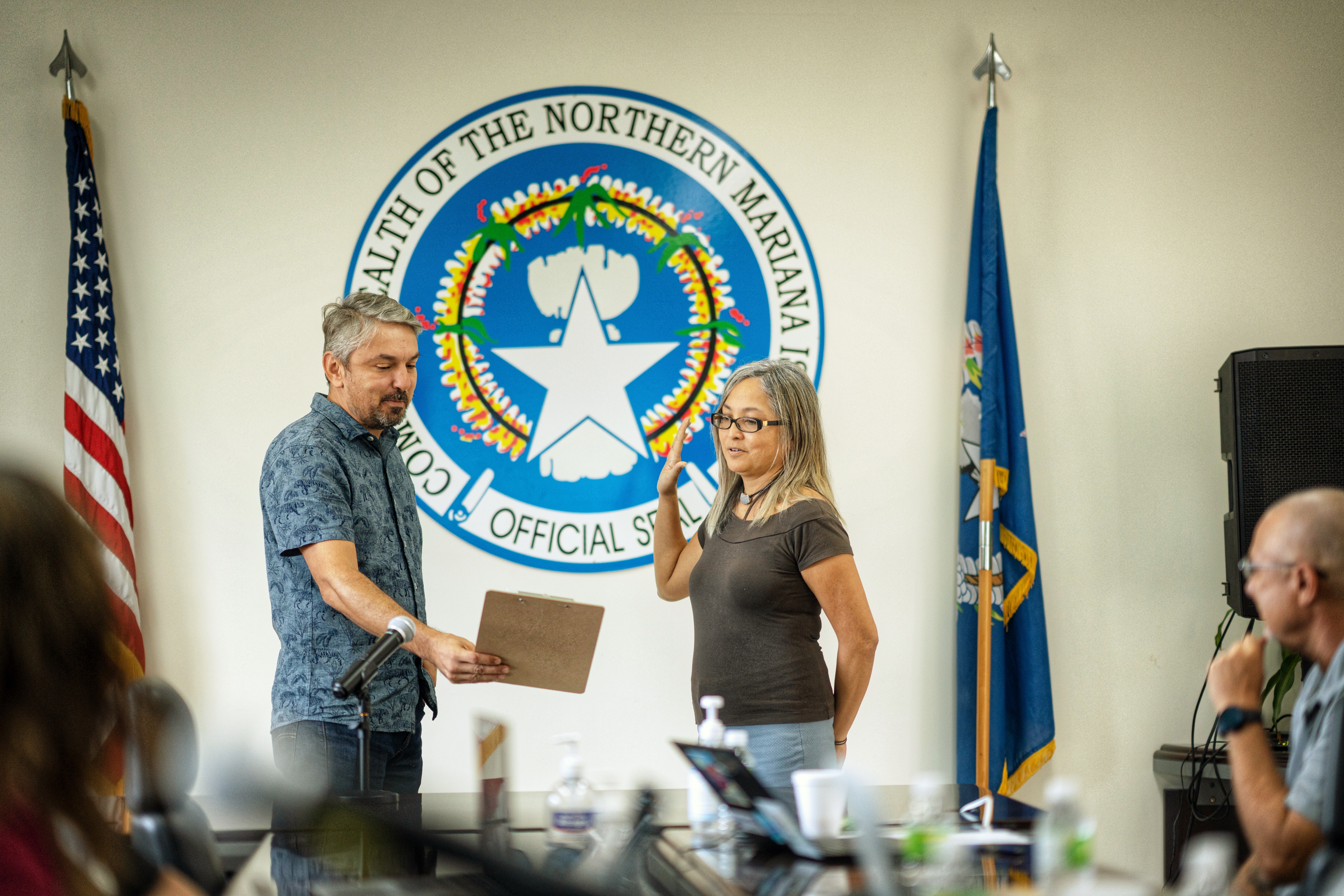 Board of Eduation legal counsel Tiberius Mocanu administers the oath of office to teacher representative Dr. Dora Borja Miura in the Office of the Commissioner of Education's conference room on Tuesday, Feb. 14, 2023.