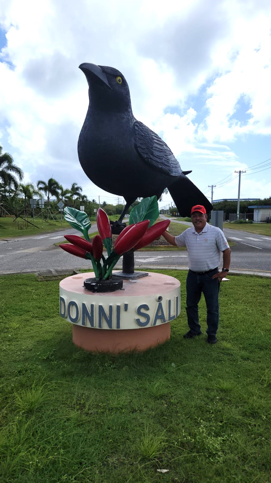 Tinian Mayor Edwin P. Aldan poses next to a statue of a Micronesian Starling or "Paluman Sali" at the San Jose roundabout on Tinian Monday.