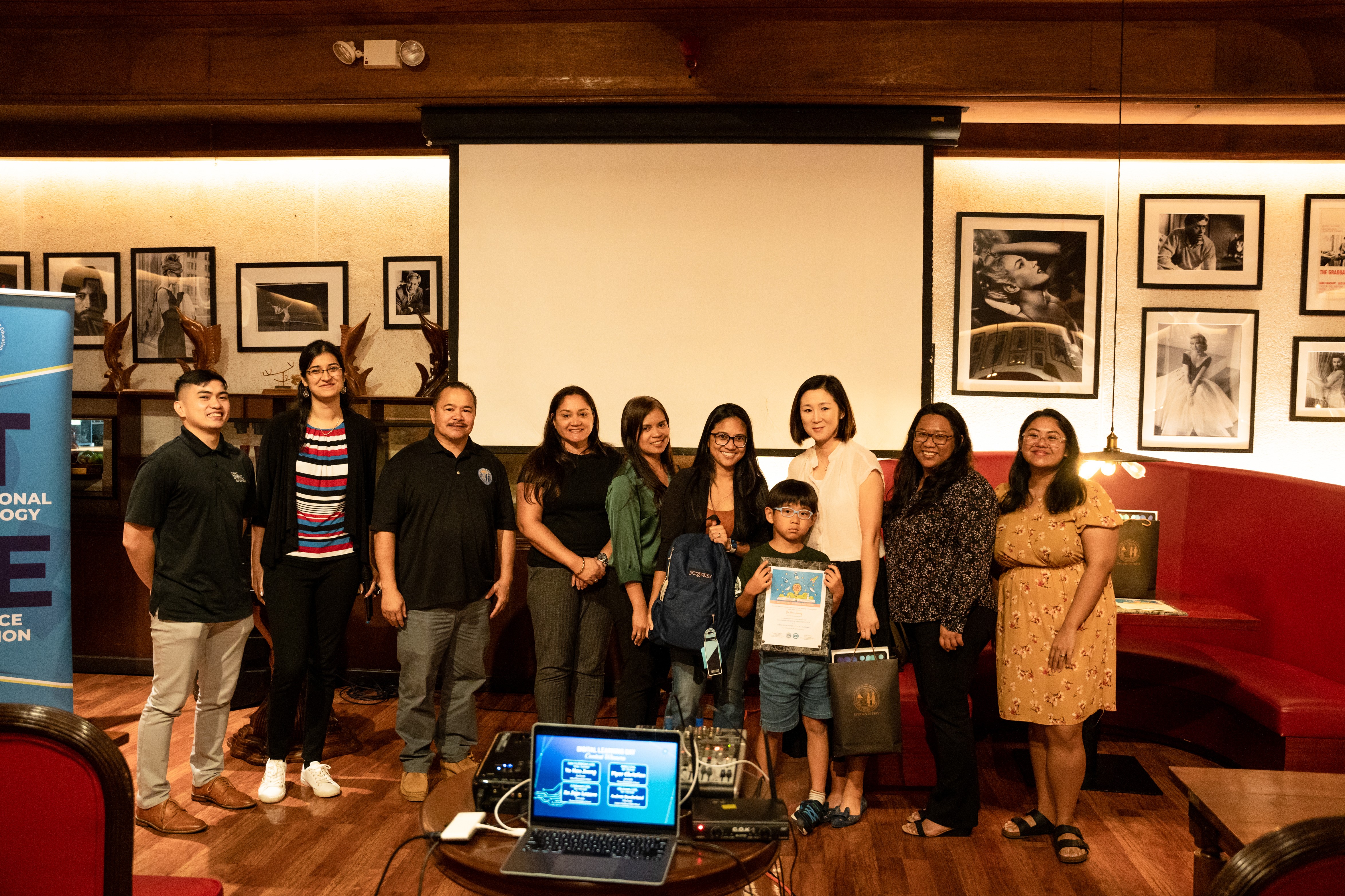 Student Yo Han Jeong with his mother, Commissioner of Education Dr. Alfred B. Ada, Instructional Technology and Distance Education Interim Director Lorraine Catienza, Special Education Director Donna Flores, and Oleai Elementary School Principal Jasylene Parico, among others.
