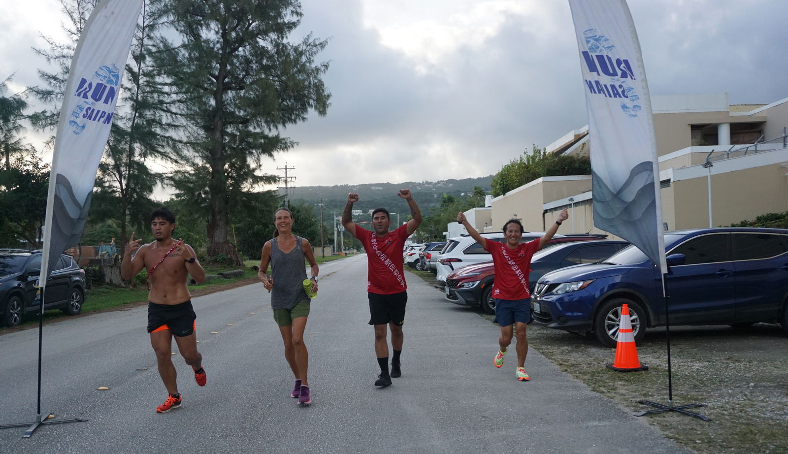 The members of Team Better Than Coffee celebrate as they cross the finish line of Marianas Ekiden '23  at  American Memorial Park on Saturday.