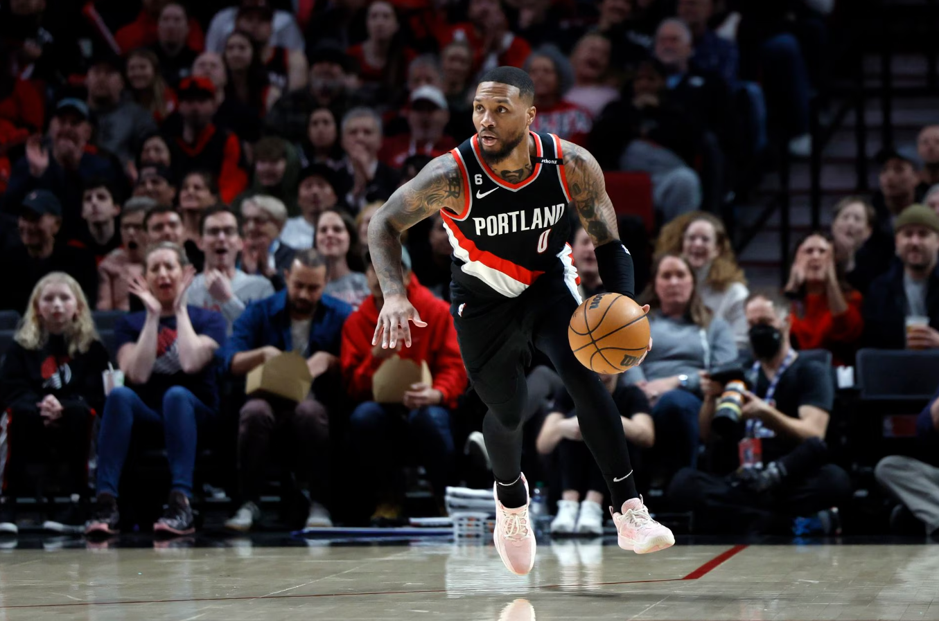 Portland Trail Blazers point guard Damian Lillard (0) dribbles the ball on a fast break during the first half against the Houston Rockets at Moda Center in Portland, Oregon, Feb. 26, 2023.
