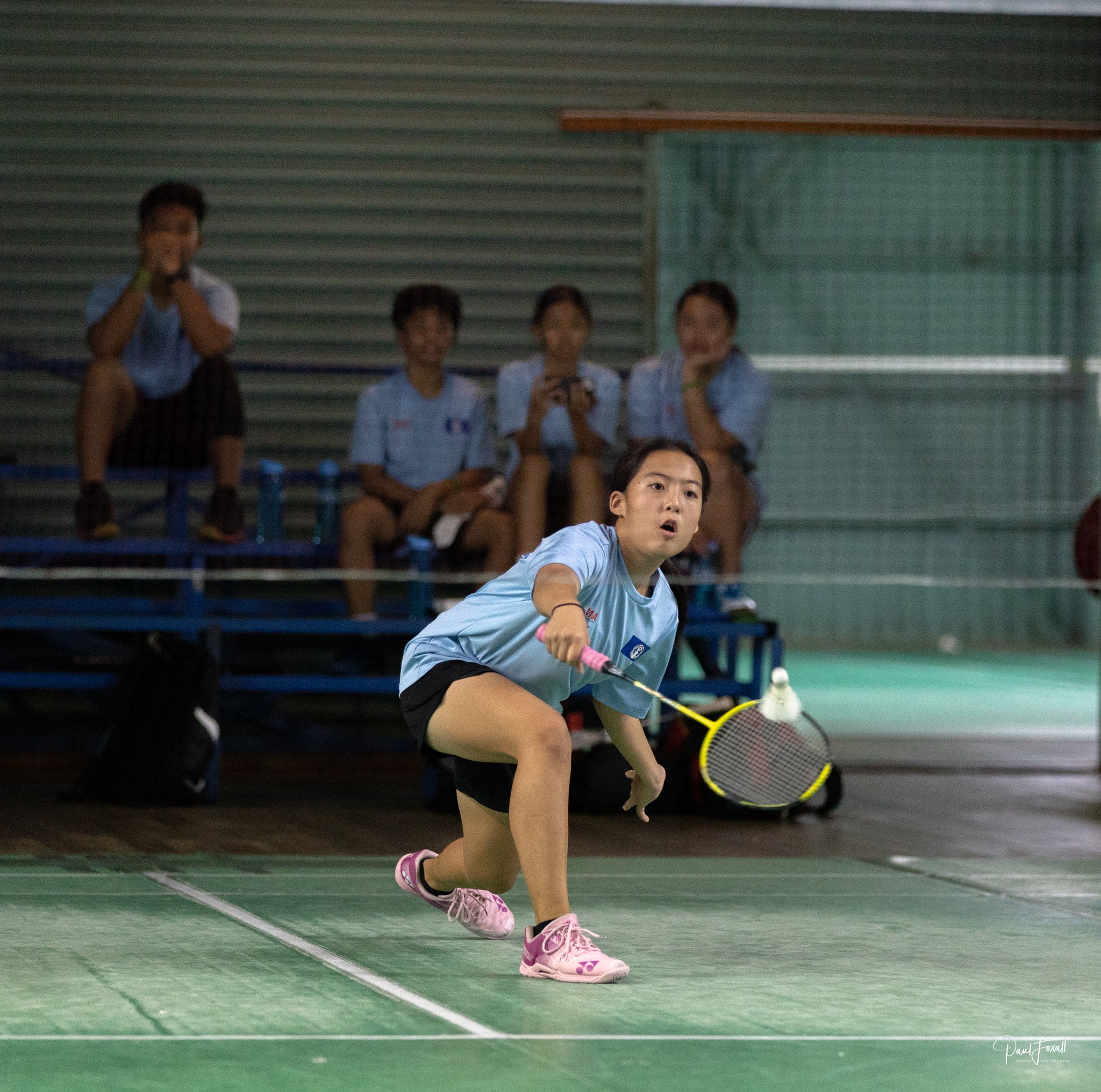 The NMI’s Lina Tsukagoshi returns to Guam’s Danielle Snaer while Tsukagoshi’s teammates watch from the bench during a singles match in the Pacific U15 Invitation Team Challenge over the weekend at the Auckland Badminton Stadium in New Zealand.