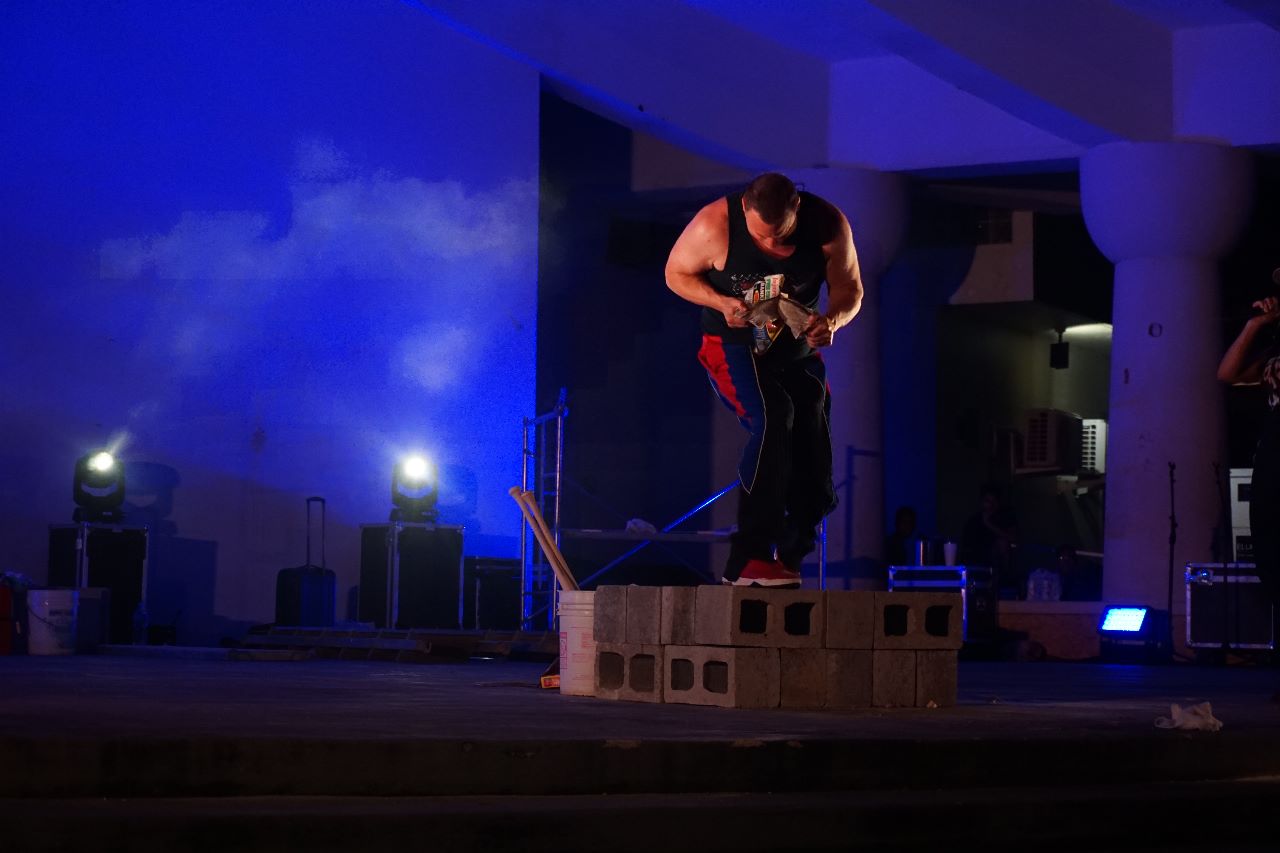 Power Team member Todd Keene tears a 2,000-page book in half with his bare hands.