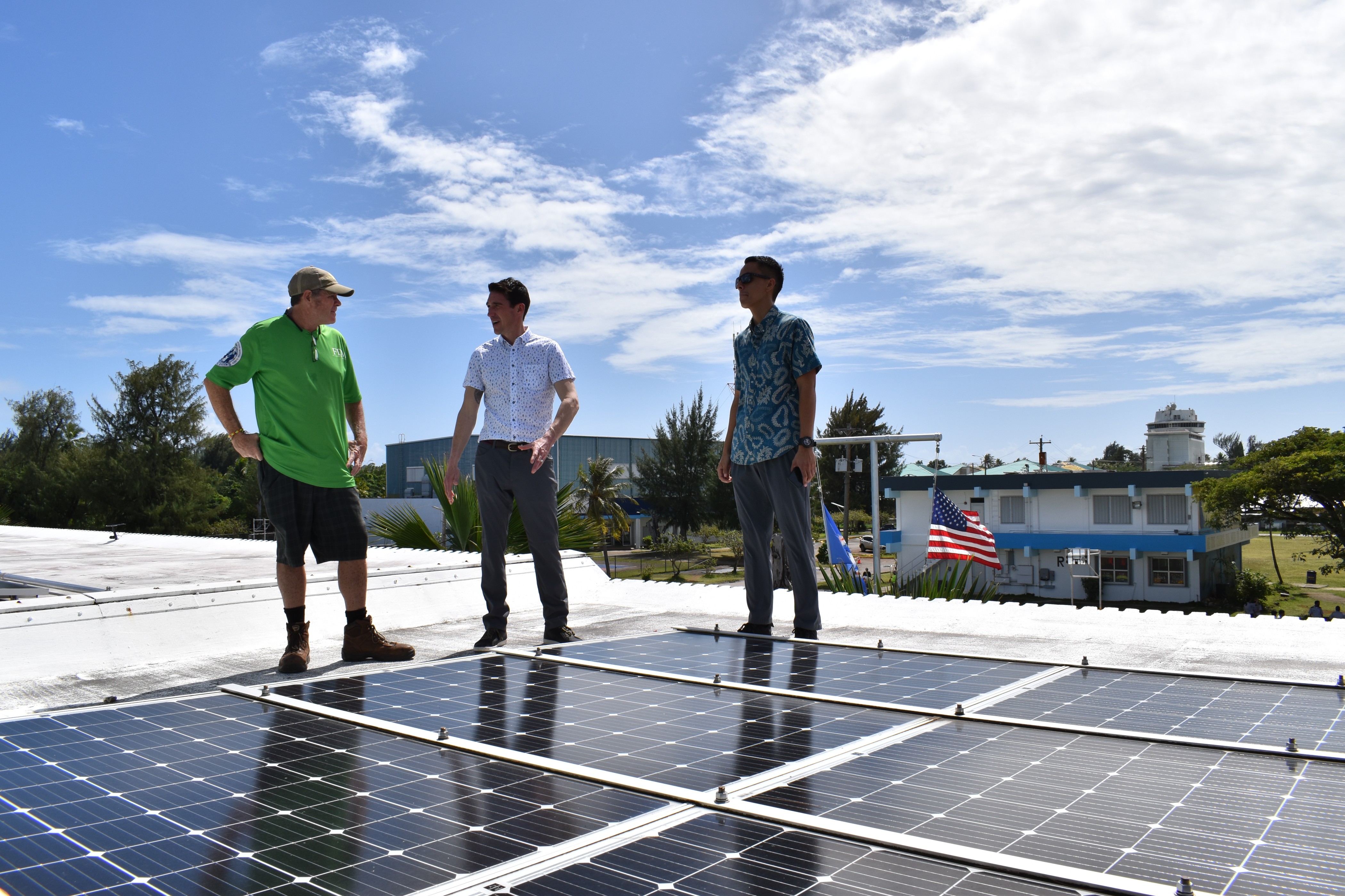 Program Manager for Facilities and Maintenance for the CNMI Public School System  Glenn Smith, the U.S. Department of Energy’s Pete Gingrass, and Office of Planning and Development Solid Waste Project Coordinator for Saipan Michael Johnson discuss the alternative energy systems currently present at Marianas High School during a tour of the school’s solar panel array on Feb. 7.