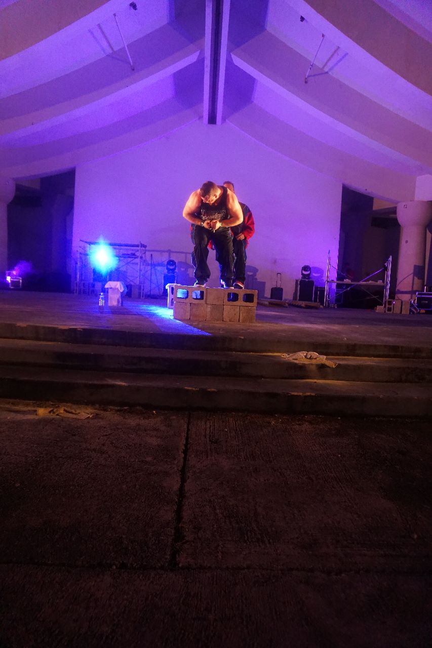 Power Team member Matt Reed bends an iron bar with his hands.