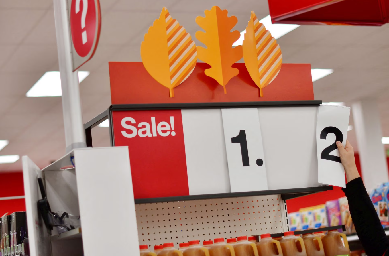 An employee alters the sale price of merchandise on a numerical sign at a Target store in King of Prussia, Pennsylvania, Nov. 20, 2020.