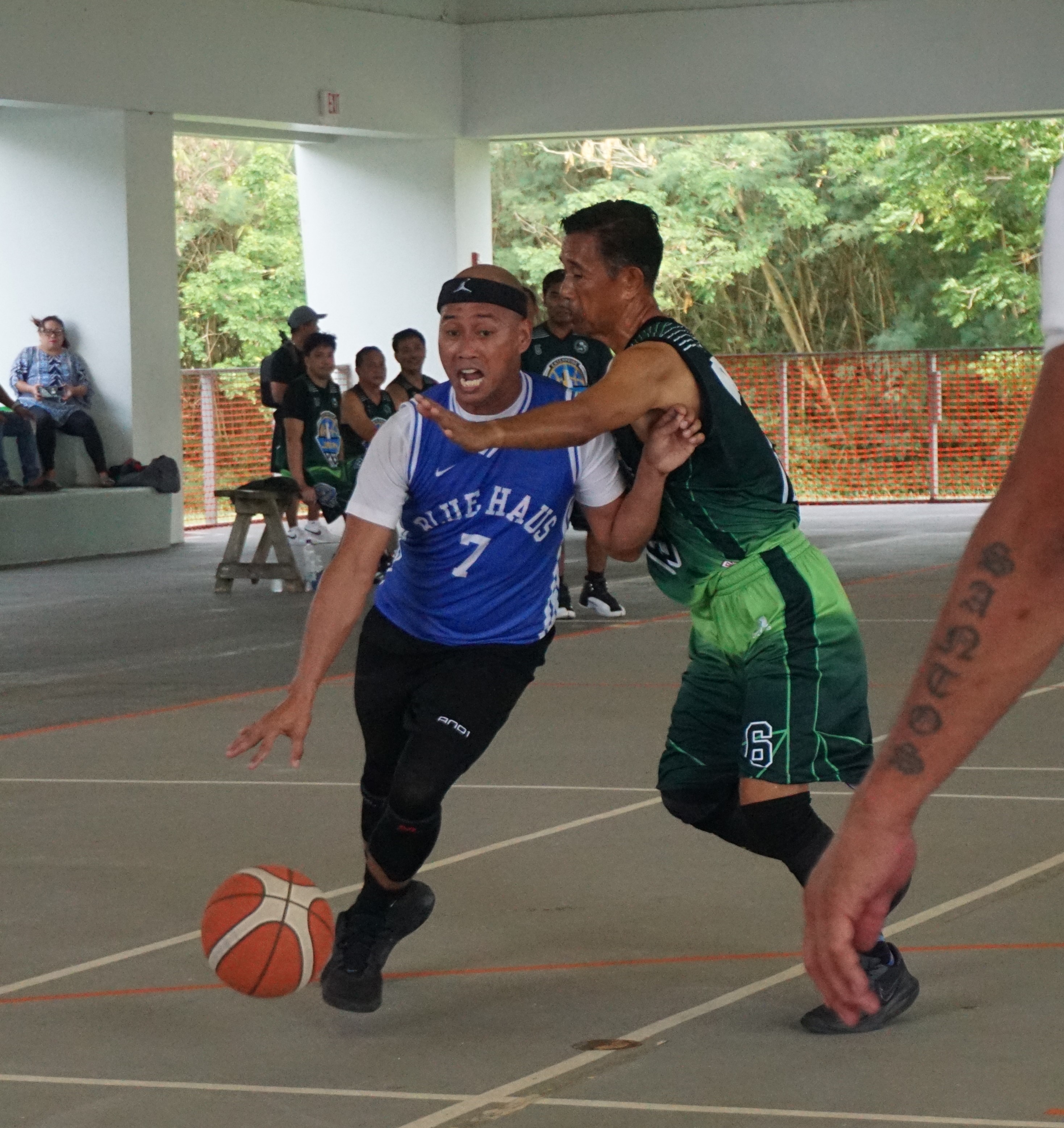 Blue Haus' Elmer Esdrelon gets fouled as he drives toward the hoop during the masters division championship game of the Legend Sports Association Invitational Basketball League at the Koblerville gym on Sunday.