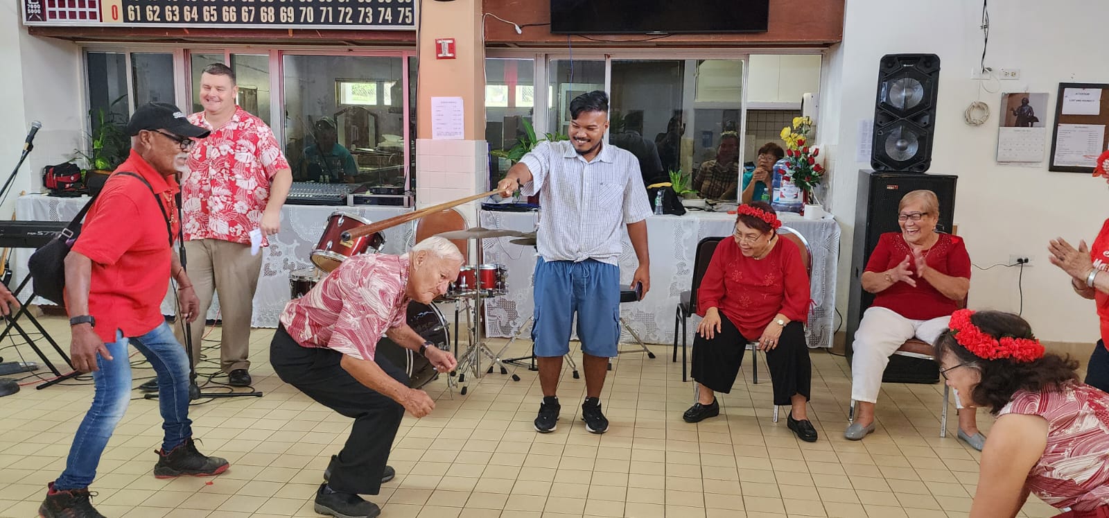 Senior citizens perform the limbo dance during the Valentine’s Day celebration at the manamko’ center on Tuesday, Feb. 14, 2023.