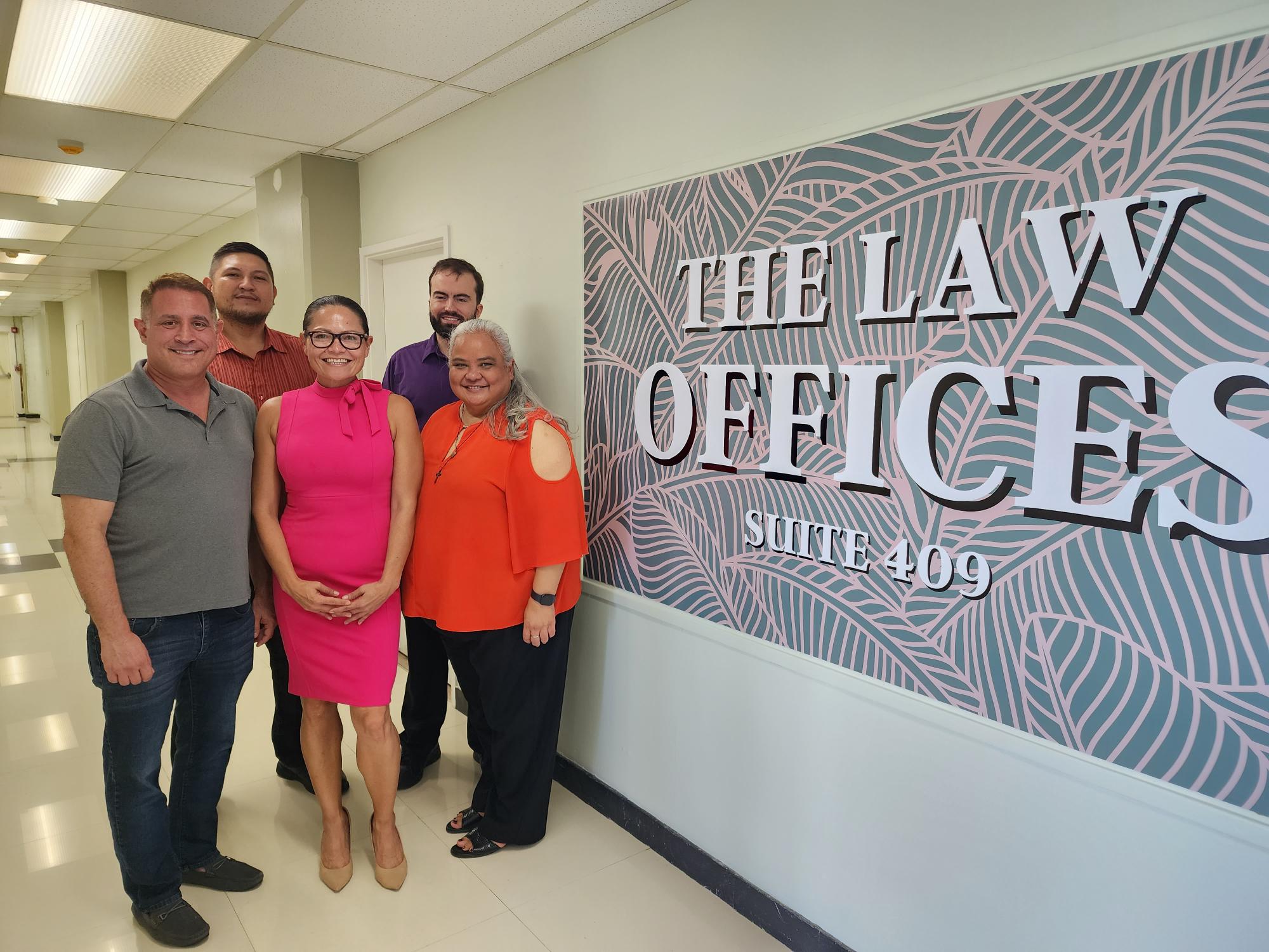 Attorneys Matthew Gregory, Viola Alepuyo, Kimberlyn King-Hinds, Anthony Aguon, and Keith Chambers pose outside their new law offices on the fourth floor of Marianas Business Plaza in Susupe on Friday.