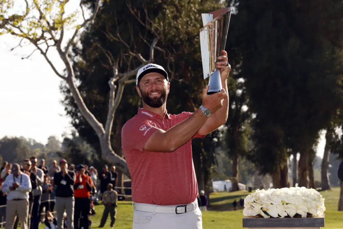 Jon Rahm hold the winner's trophy after winning the Genesis Invitational golf tournament at Riviera Country Club, Sunday, Feb. 19, 2023, in the Pacific Palisades area of Los Angeles.