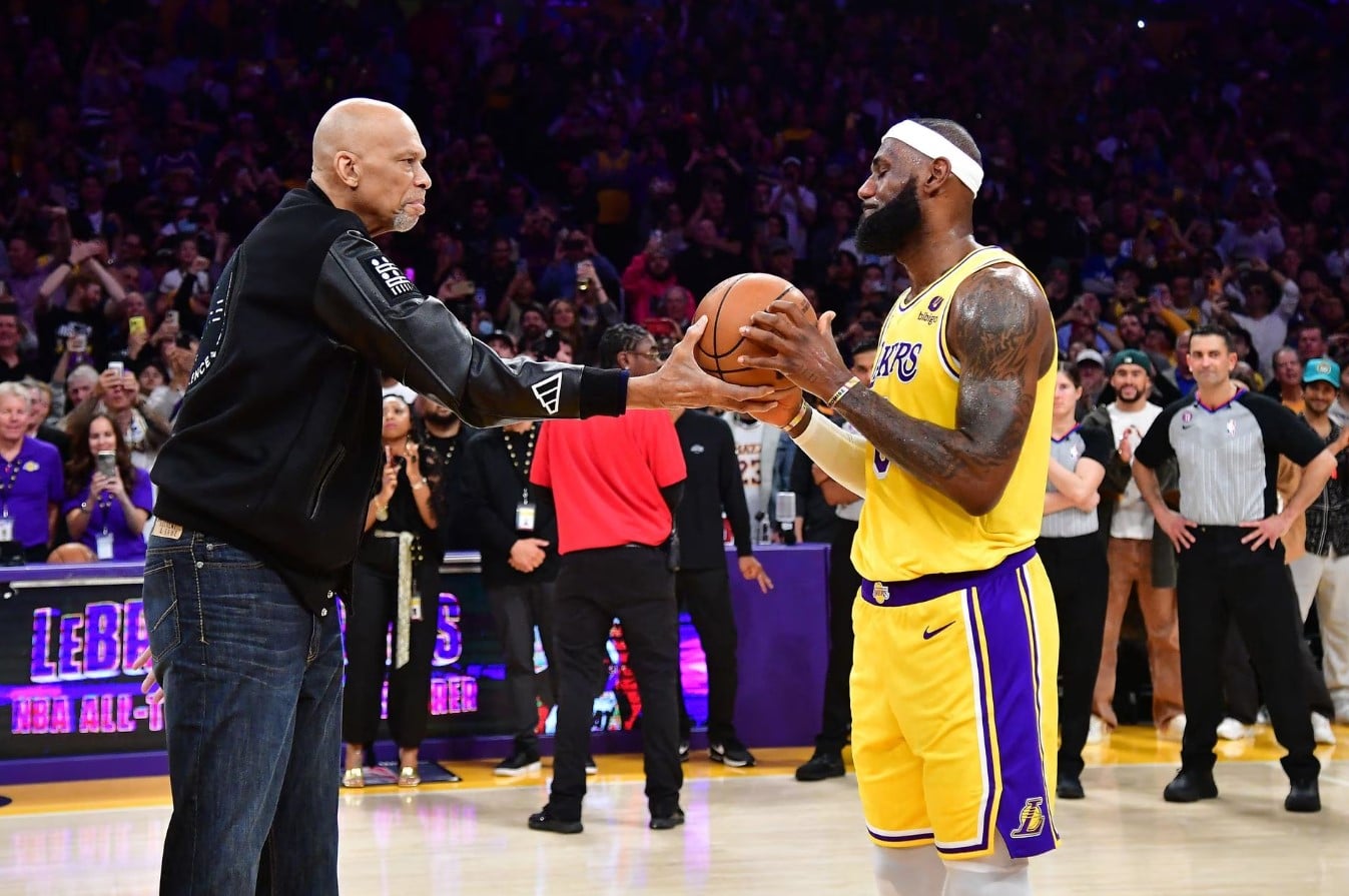 Former Los Angeles Lakers player Kareem Abdul-Jabbar hands the game ball to forward LeBron James (6) after James becomes the NBA all-time scoring leader against the Oklahoma City Thunder during the second half at Crypto.com Arena in Los Angeles, California, Feb 7, 2023.
