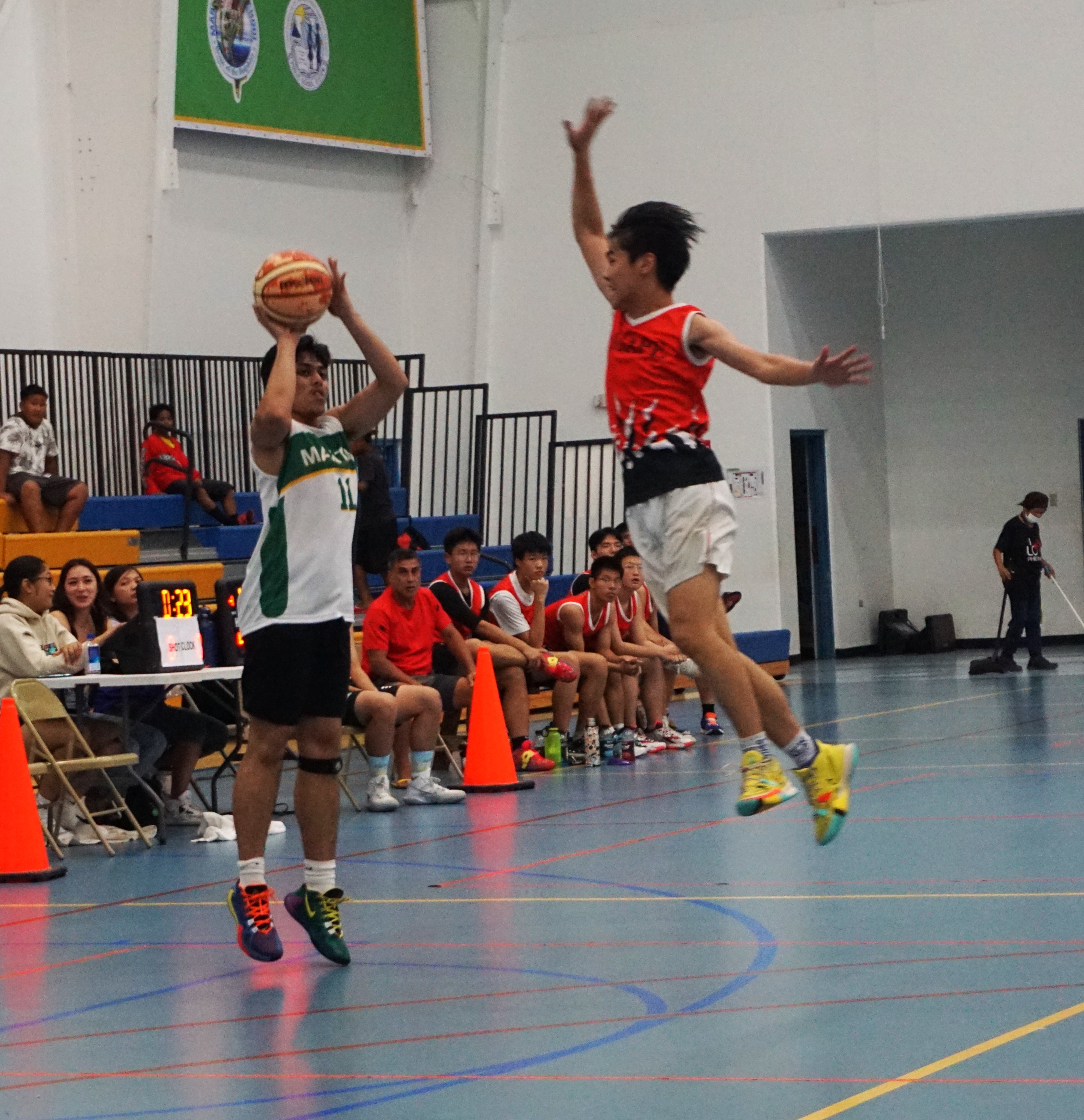 SSHS's Elijah Garcia takes the contested three-point shot during a boys high school division game of the IT&E Interscholastic Basketball League on Wednesday at the MHS gym.