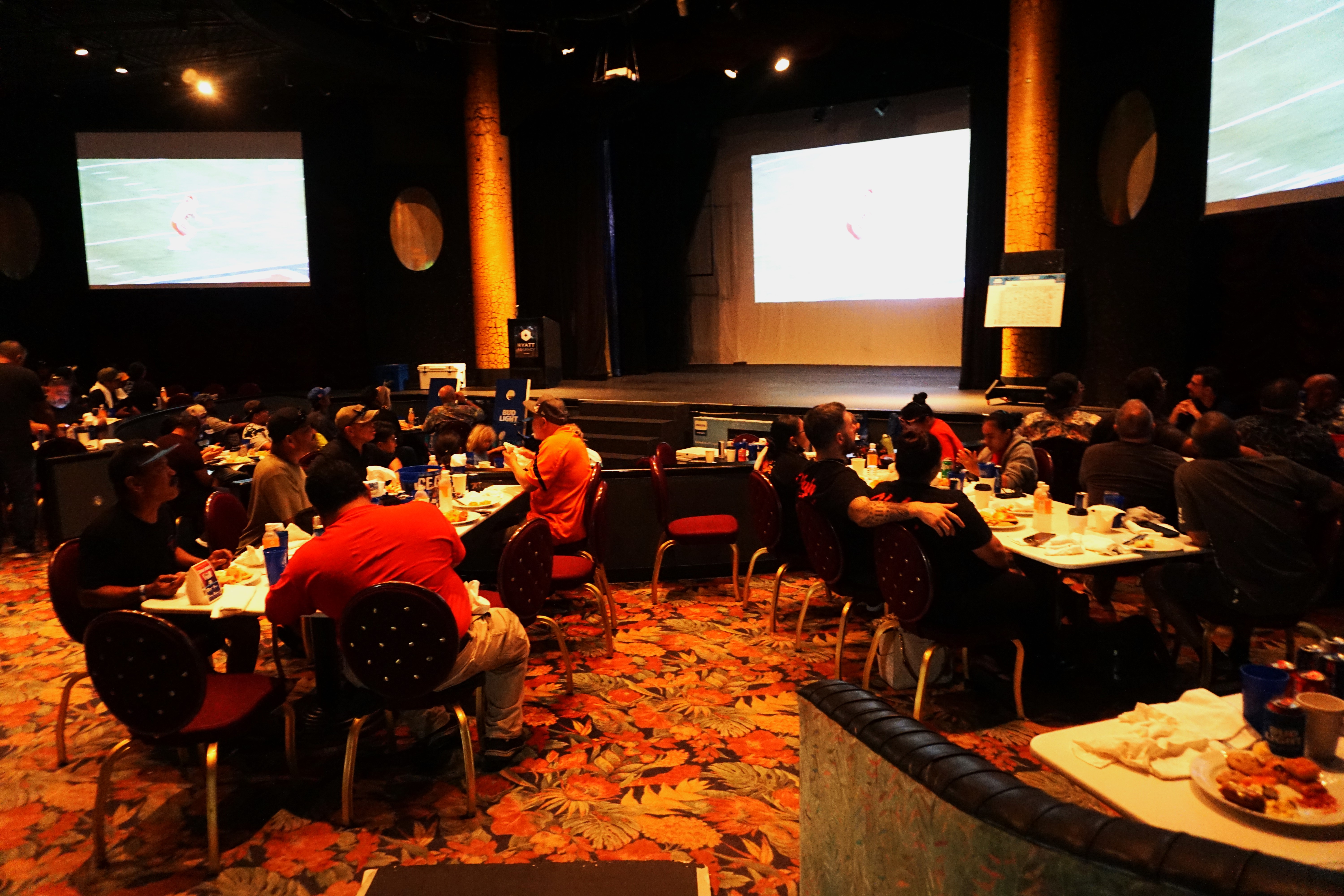 The theatre showroom of the Hyatt Regency Saipan is filled with local football fans.