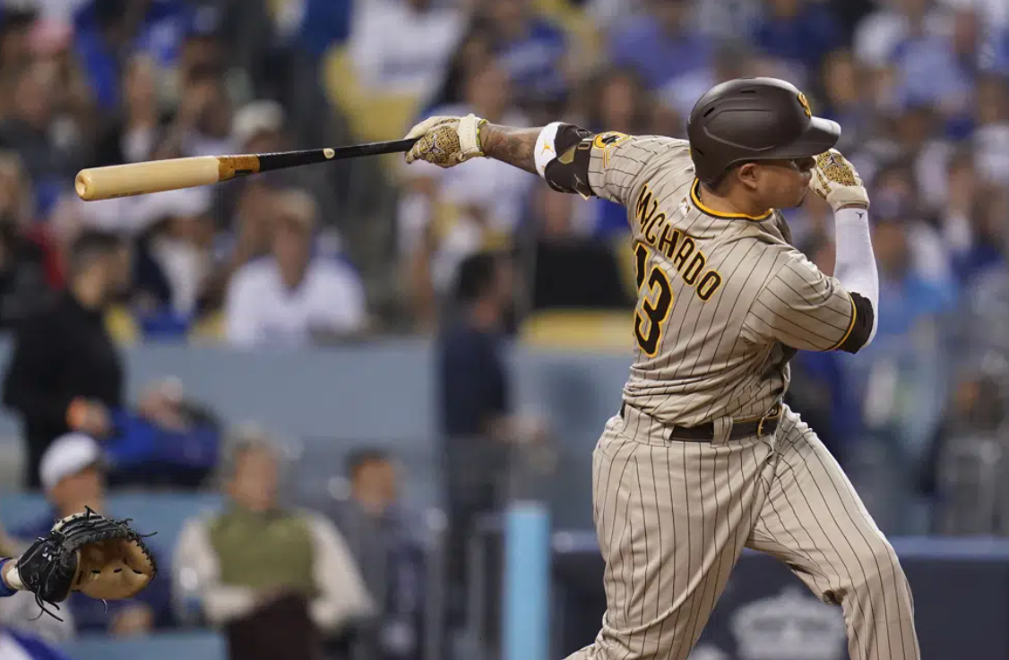 San Diego Padres' Manny Machado follows through on an RBI-double during the third inning in Game 2 of a baseball NL Division Series against the Los Angeles Dodgers, Oct. 12, 2022, in Los Angeles.