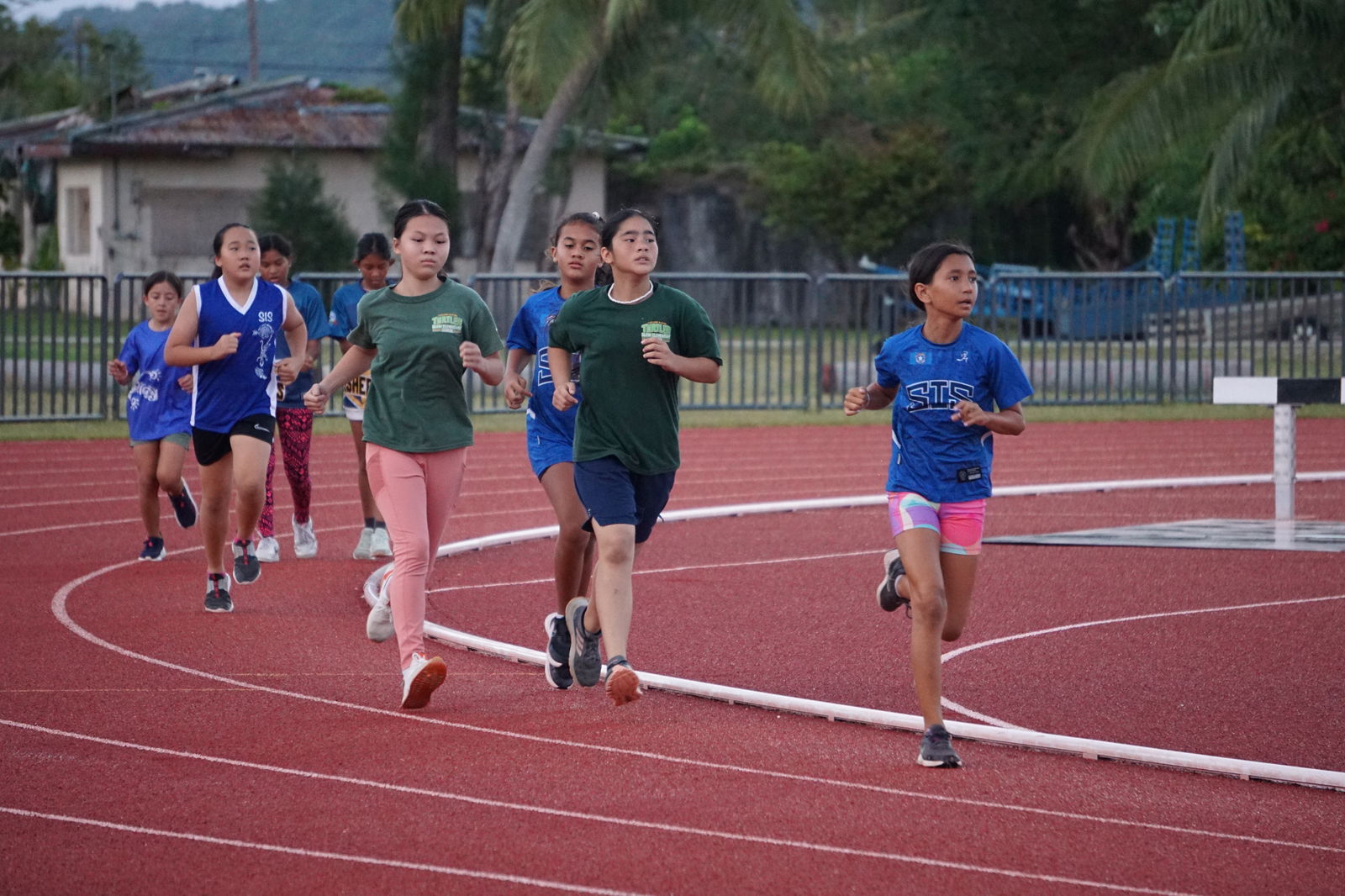SIS's Leilani Ruszala leads the U12 Girls 800m group on opening day of the PSS-NMA All School Athletics at the Oleai Sports Complex on Tuesday.