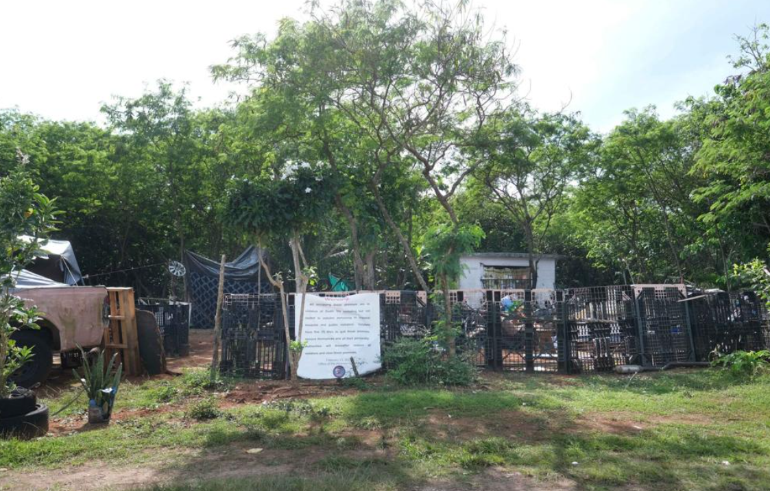 An encampment with makeshift fencing and personal property is seen Tuesday, Feb. 28, 2023, in Dededo, Guam.