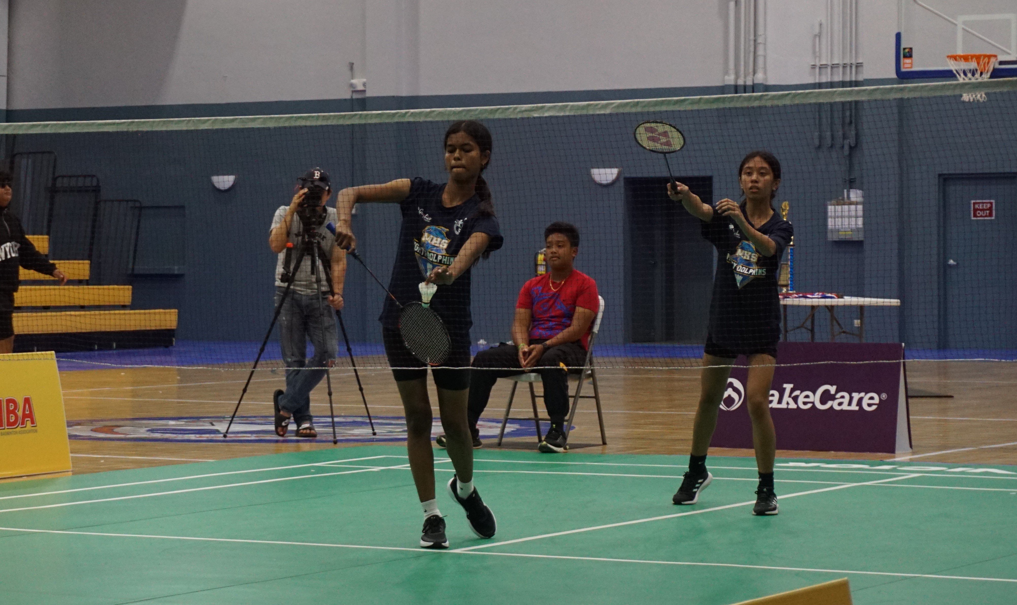 An MHS 2 player sets up for the serve during the girls doubles event.