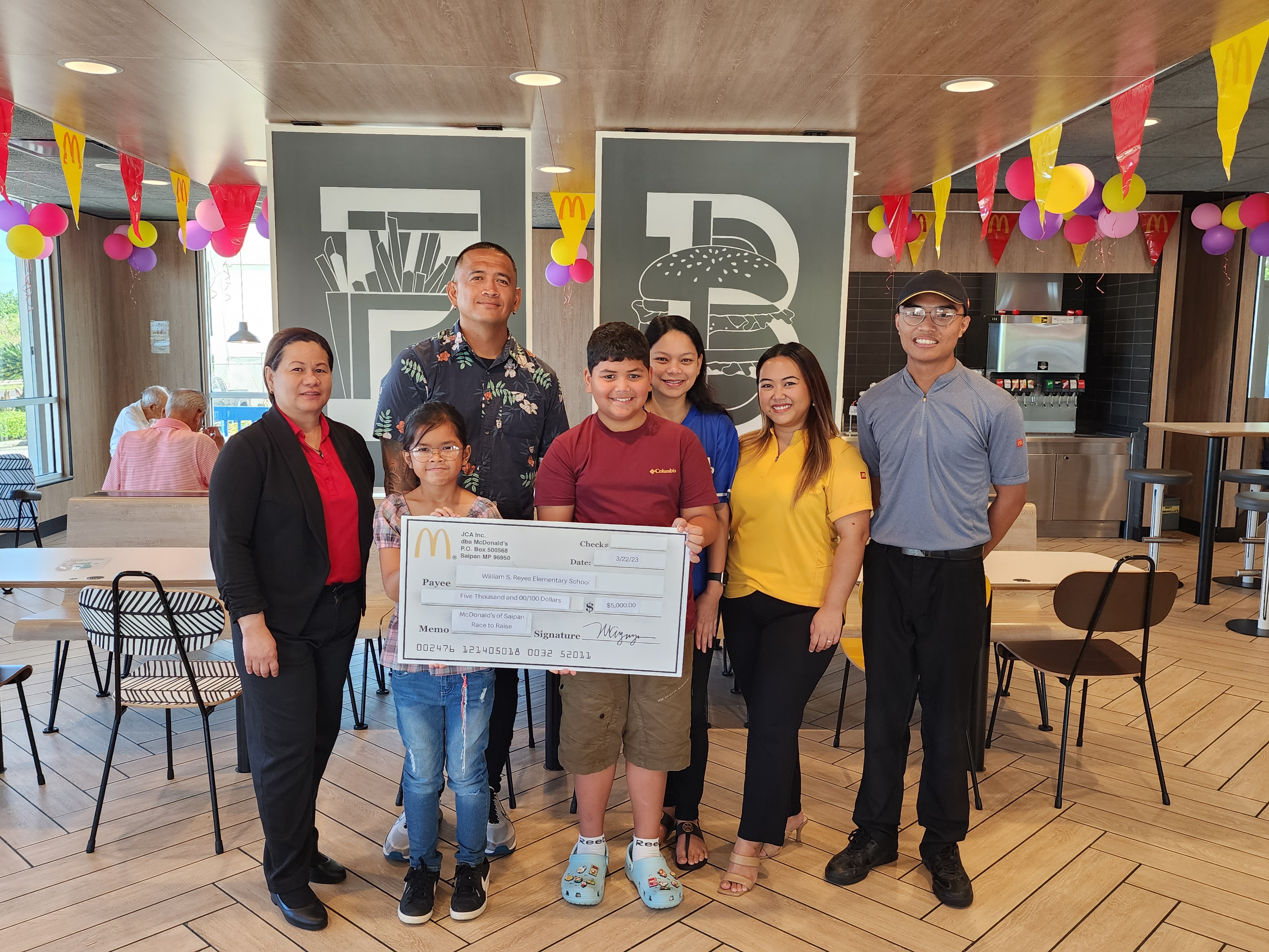 WSR students, WSR PTSA President Marlon Cabrera and WSR Vice Principal Jocelyn Manibusan receive a ceremonial check for $5,000 cheque from McDonald’s  on Wednesday at its Chalan Laulau branch on Middle Road. Also in  photo are McDonald’s GM Joyce Asistores, McDonald’s of Guam and Saipan Executive Assistant to the President Mable Glenn and McDonald’s crewmember  John Michael Navarro.