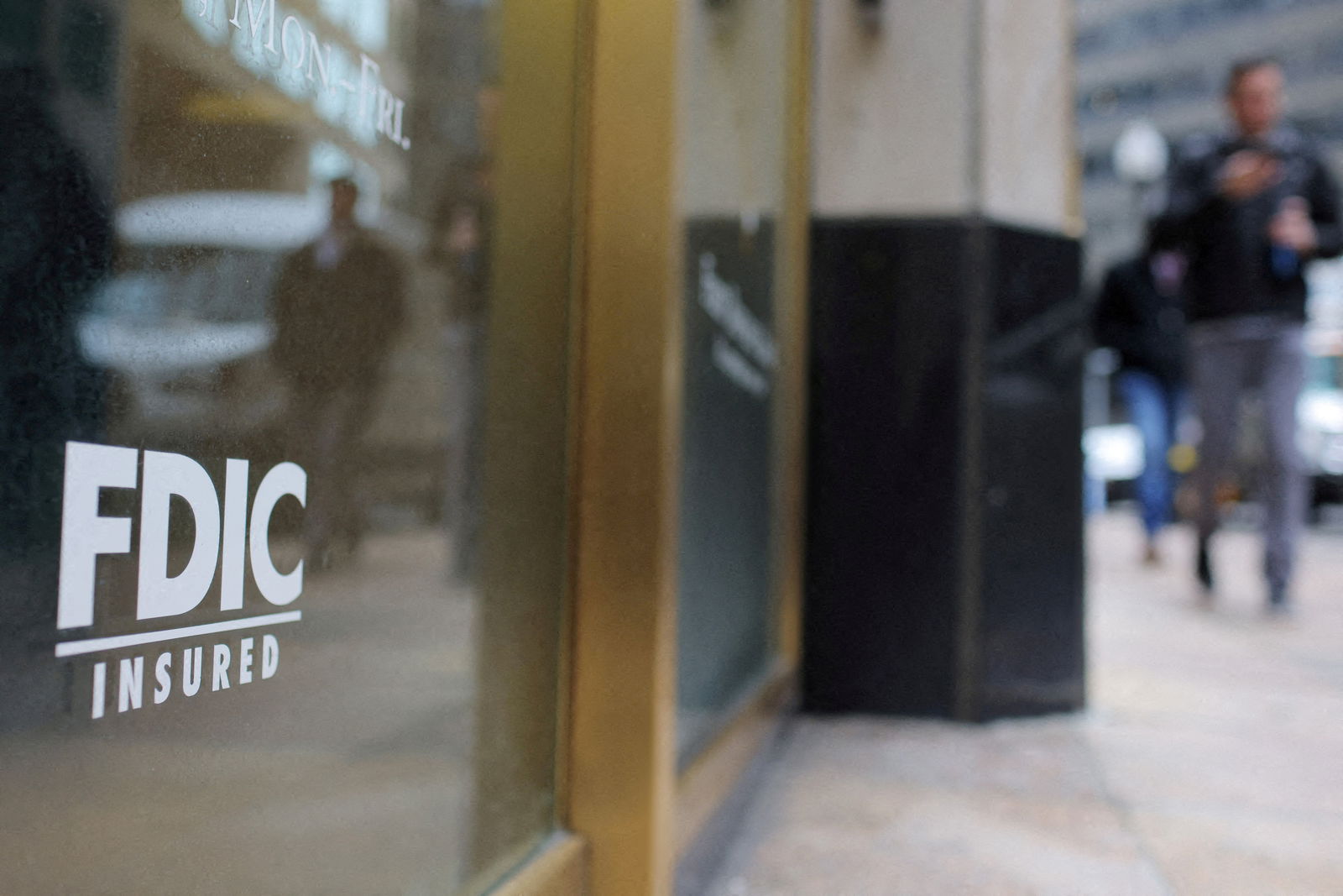 A sign reads “FDIC Insured” on the door of a branch of First Republic Bank in Boston, Massachusetts,  March 13, 2023.