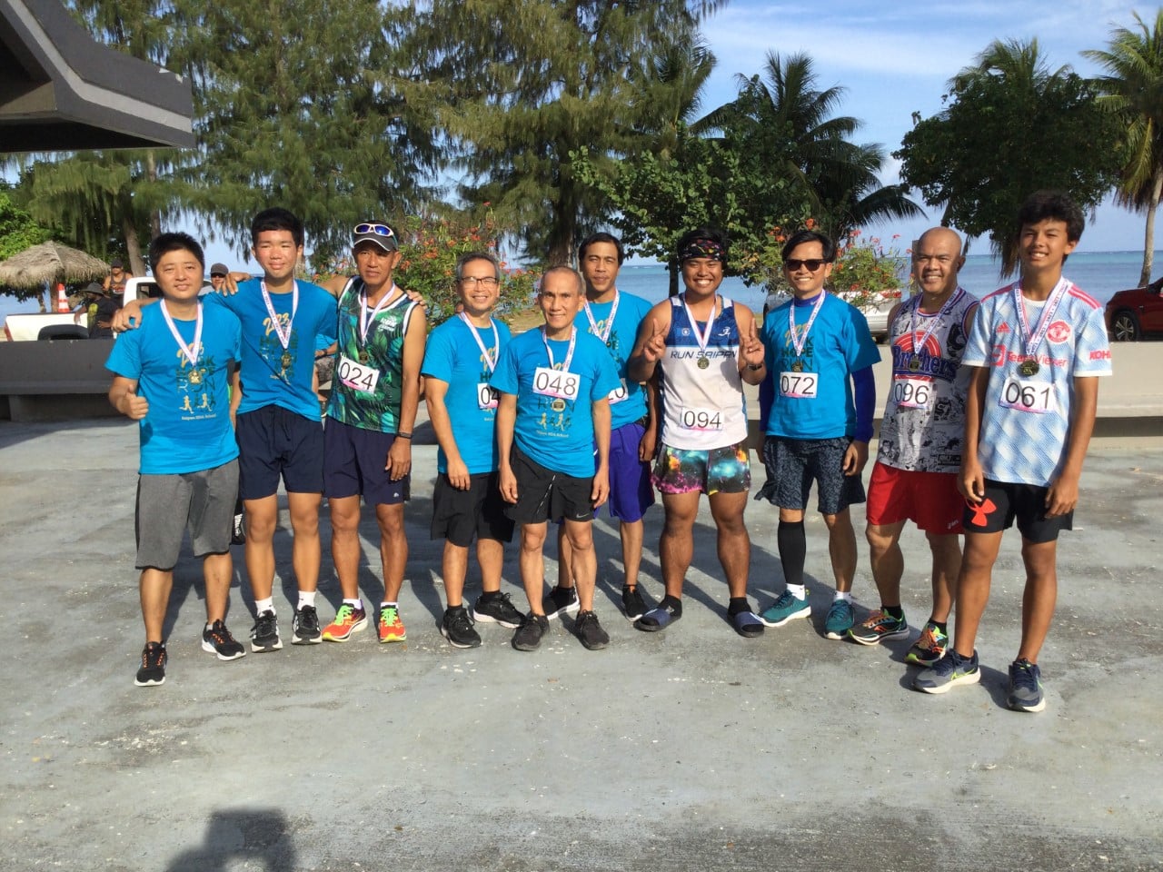 The top 10 runners pose for a photo after completing the Saipan Seventh-day Adventist School 5K Hope Run at the Civic Center on Sunday.