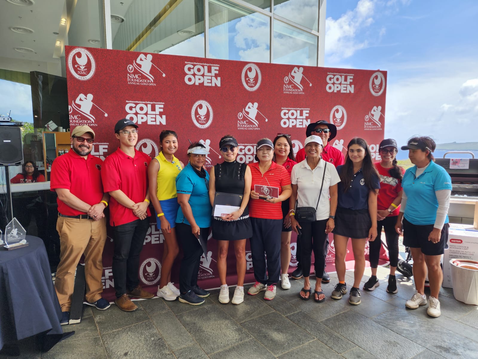 The top 3 ladies open flight players —  Me Ae Jeon, Tyanna Jacot, and Zhimin Jin — pose for a photo with NMC and tournament officials during the NMC Golf Open awards ceremony at the LoaLao Bay Golf & Resort on Sunday. 