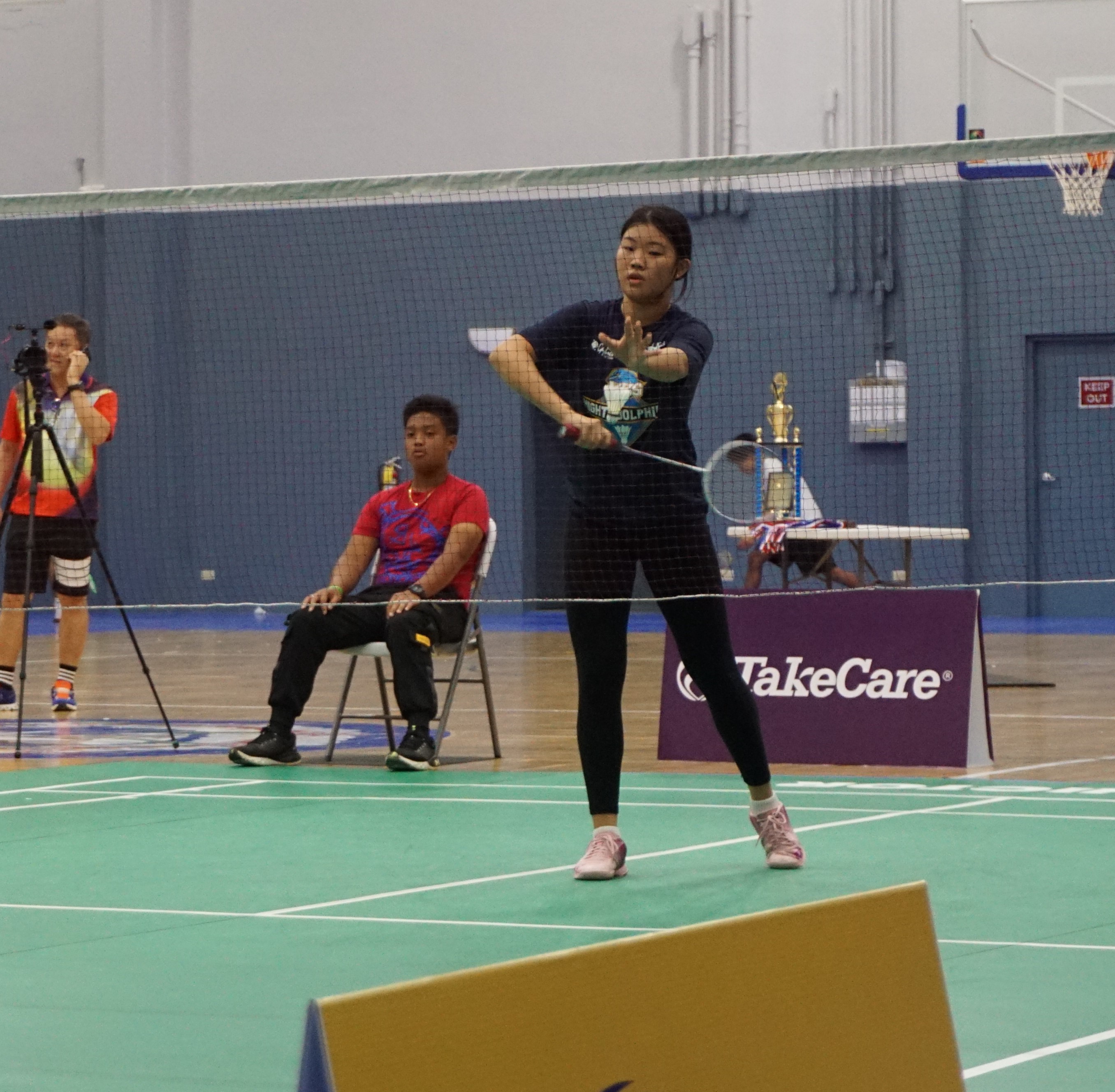 MHS 1's Terresa Ahn attempts the serve against ACS 1 during the girls singles event of the TakeCare-PSS Interscholastic Badminton League championship at the Ada gym on Saturday.