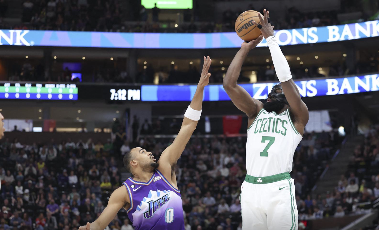 Boston Celtics guard Jaylen Brown (7) shoots a three point shot over Utah Jazz guard Talen Horton-Tucker (0) in the first quarter at Vivint Arena in Salt Lake City, Utah, March 18, 2023.