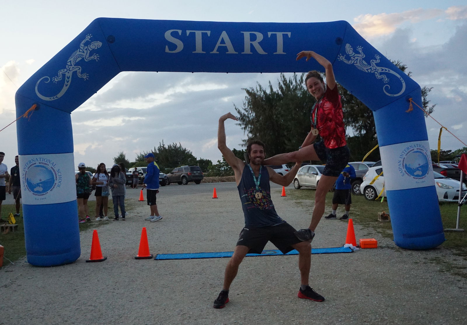 Michael Denevan and Lily Muldoon strike a pose as the top finishers of the CHCC Happy Hearts 5K '23 at the Garapan Fishing Base on Friday.