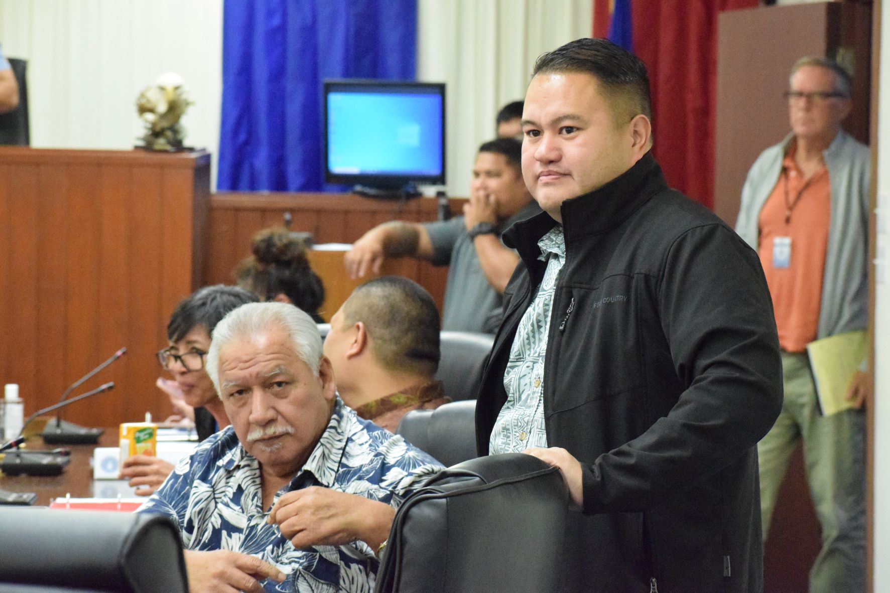 Reps. Roman C. Benavente, seated, and Manny Castro in the House chamber on Monday.