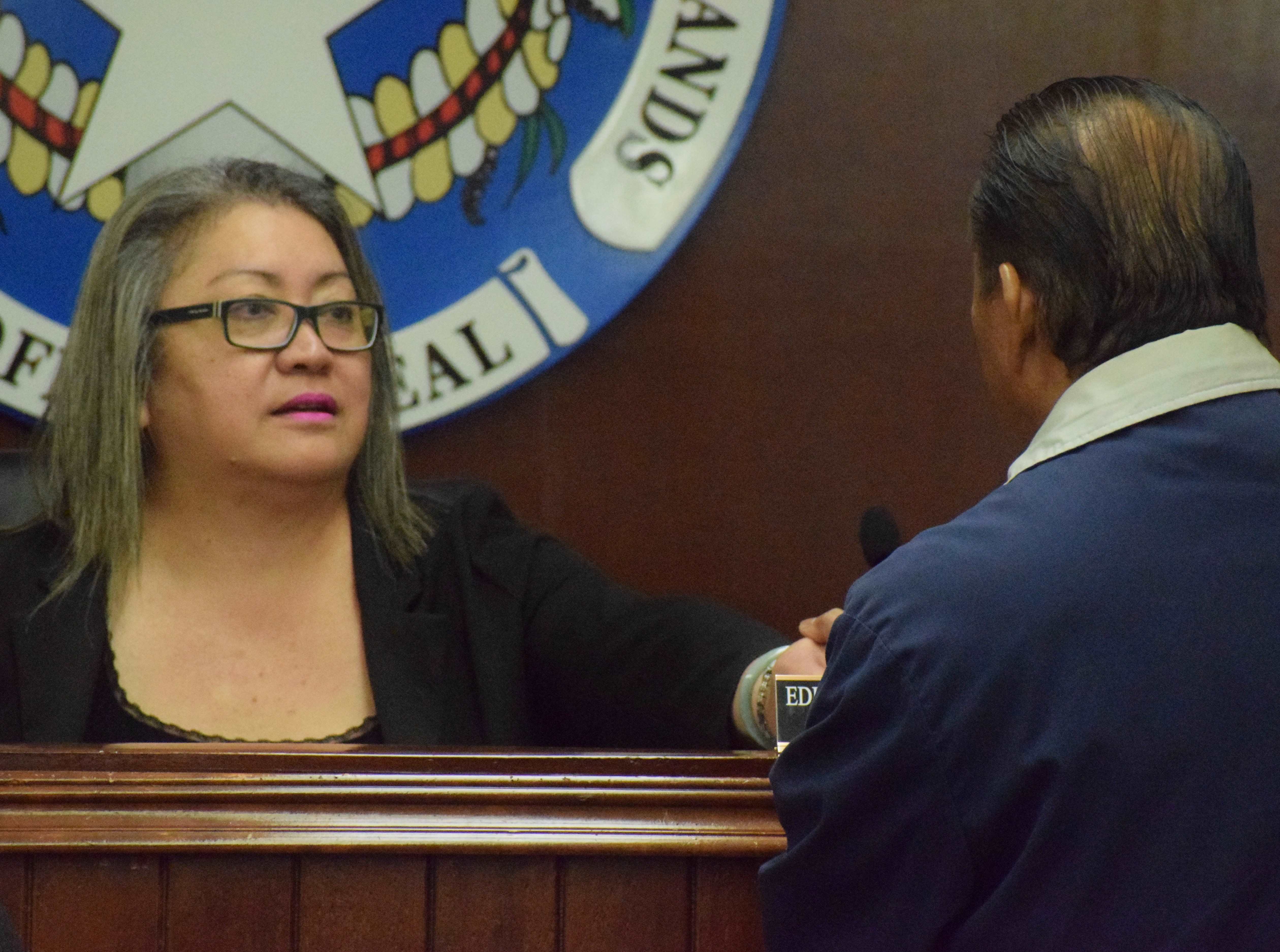 Senate President Edith Deleon Guerrero confers with Sen. Frank Q. Cruz during Senate emergency session on Monday.