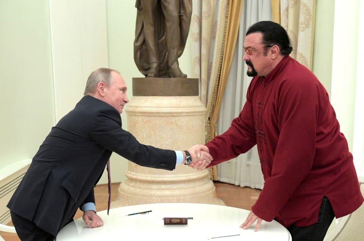 Russia's President Vladimir Putin, left, shakes hands with U.S. actor Steven Seagal during a meeting at the Kremlin in Moscow, Russia, Nov. 25, 2016.