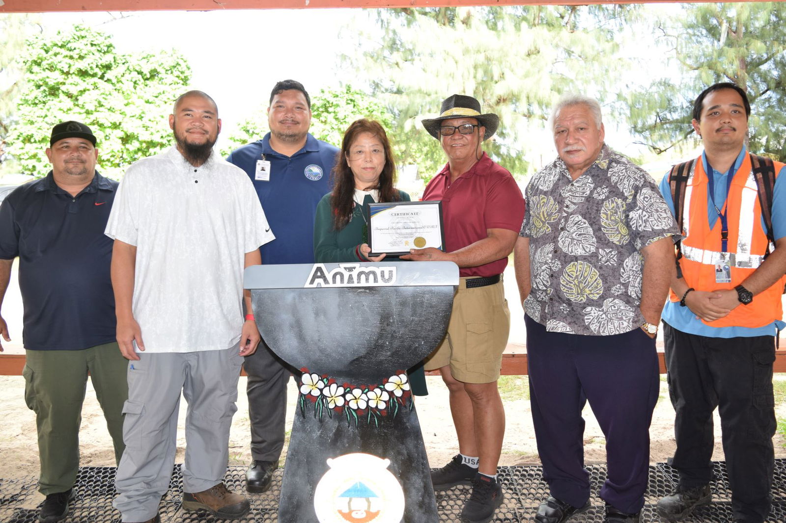 Imperial Pacific International majority owner Cui Lijie, center, receives an adopt-a-place program certificate from Saipan Mayor Ramon Blas "RB" Camacho, third right, as they pose for a photo with Rep. Roman Benavente, second left, and staff members of regulatory agencies at San Antonio beach on Wednesday.