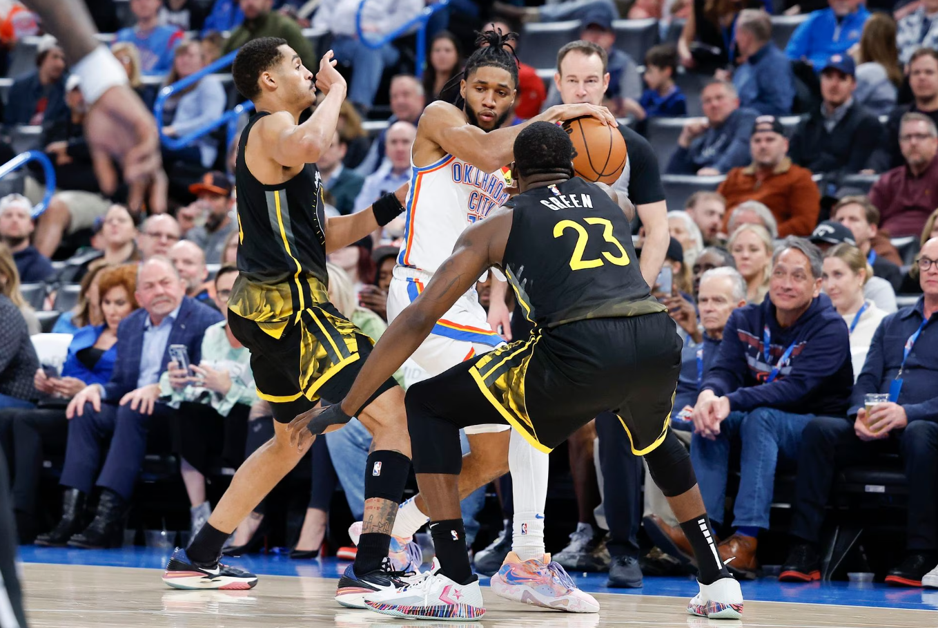 Oklahoma City Thunder guard Isaiah Joe (11) is defended by Golden State Warriors guard Jordan Poole (3) and forward Draymond Green (23) during the second half at Paycom Center in Oklahoma City, March 7, 2023.