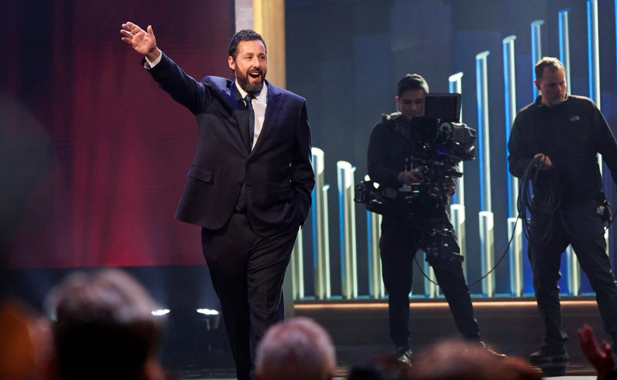 Actor and comedian Adam Sandler waves as he is awarded the Mark Twain Prize for American Humor at the Kennedy Center in Washington, D.C., March 19, 2023.