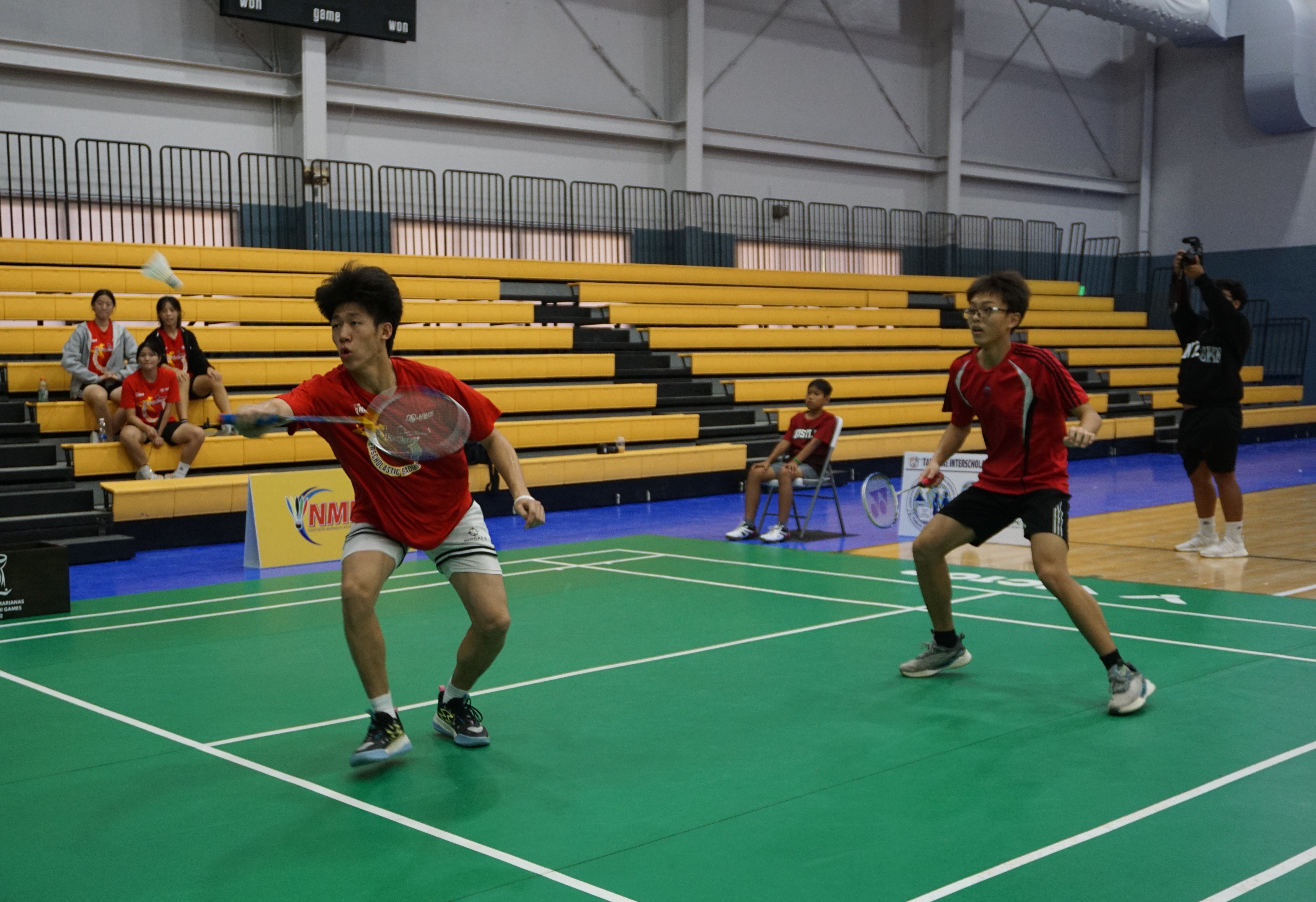 An ACS 2 player reaches for the return in the boys doubles event.