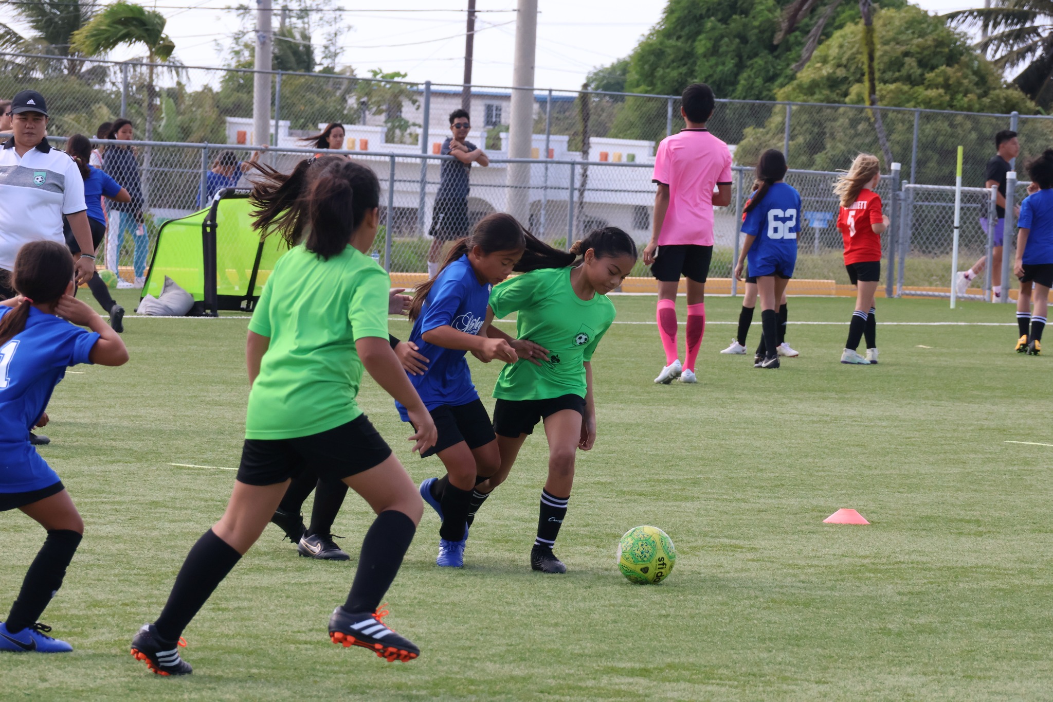 Tan Holdings and Shirley's players battle for the possession during a U14 girls division game of the TakeCare Youth Soccer League at the NMI Soccer Training Center in Koblerville.