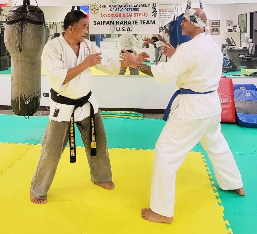 Sensei Danny Banez and Jerry Diaz practice karate techniques at the Kyokushinkai Karate Dojo.
