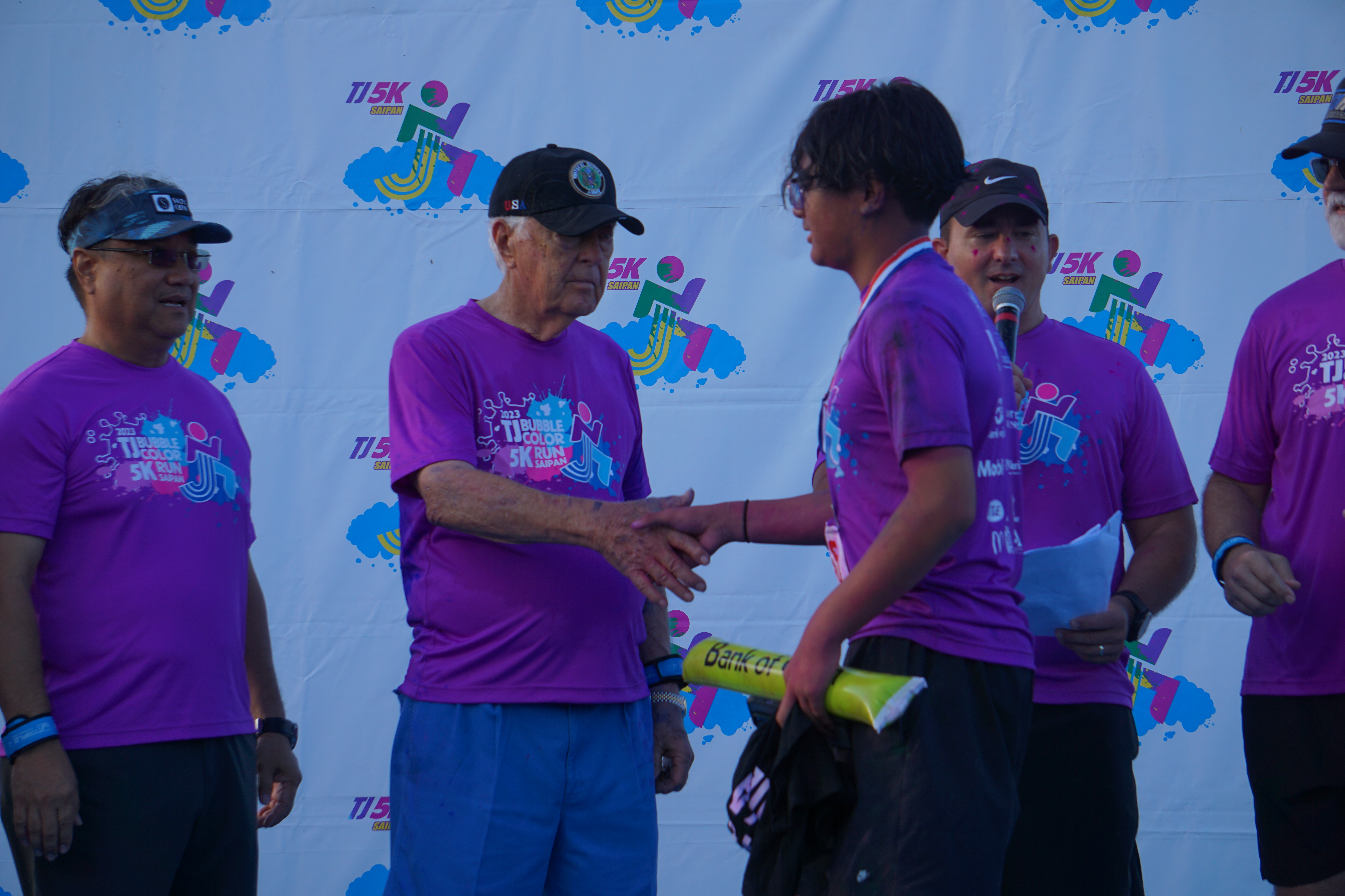 Triple J Chairman & CEO Robert Jones congratulates one of the top runners.