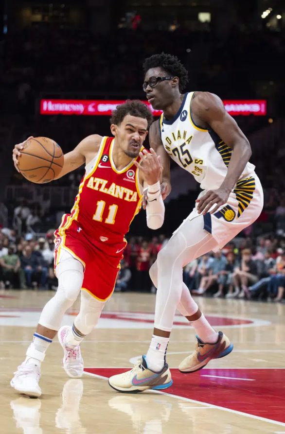 Atlanta Hawks guard Trae Young drives past Indiana Pacers forward Jalen Smith during the first half of an NBA basketball game, Saturday, March 25, 2023, in Atlanta.