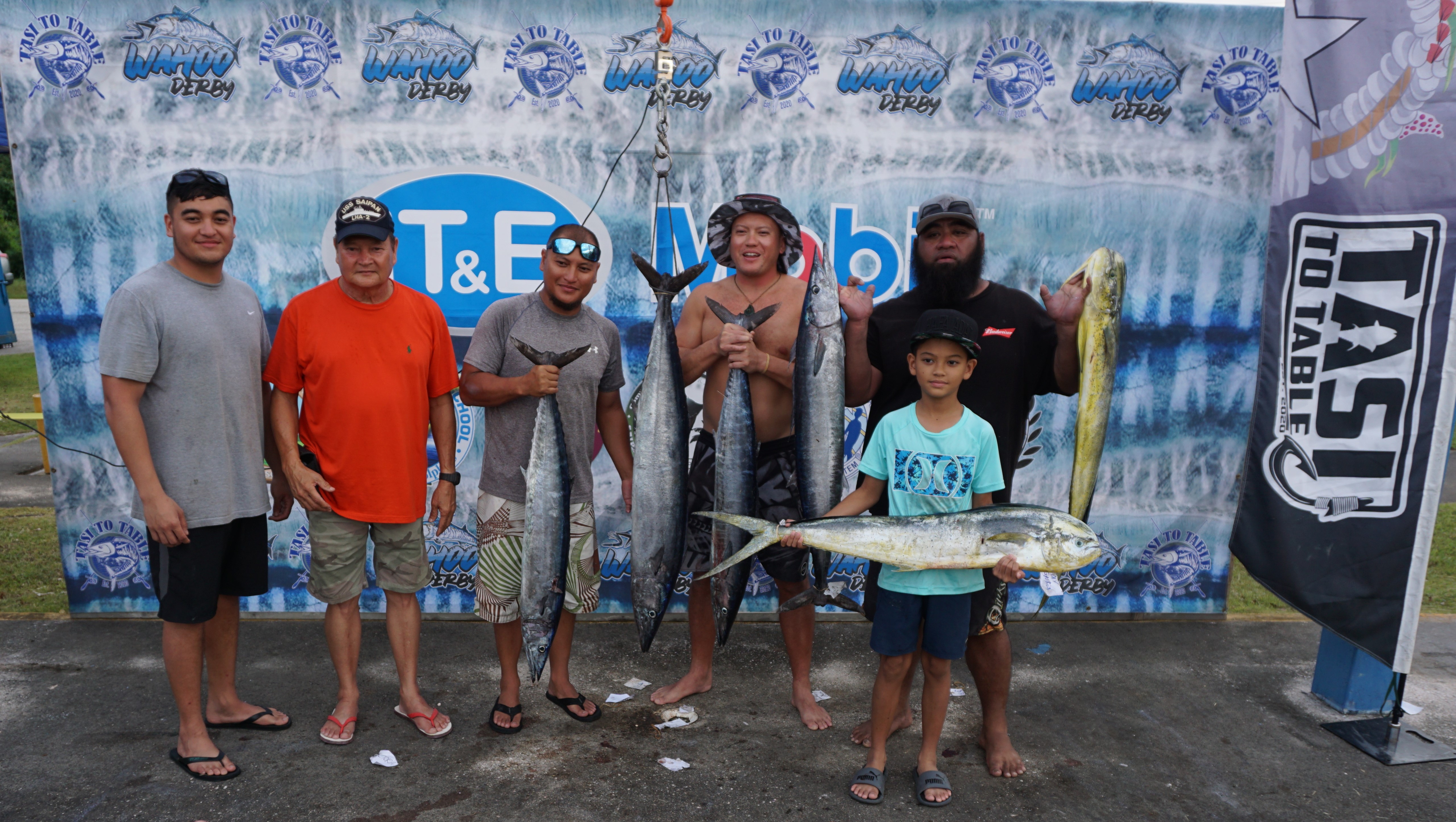 MV Gloria II Captain John T. Sablan, 2nd left, and crew pose with their winning catches during the TTT Wahoo in the Marianas Fishing Derby at Smiling Cove Marina on Saturday.
