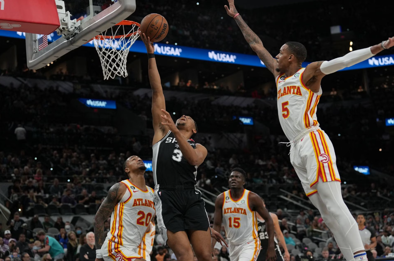 San Antonio Spurs forward Keldon Johnson (3) shoots in front of Atlanta Hawks guard Dejounte Murray (5) in the first half at the AT&T Center in San Antonio, Texas, March 19, 2023.