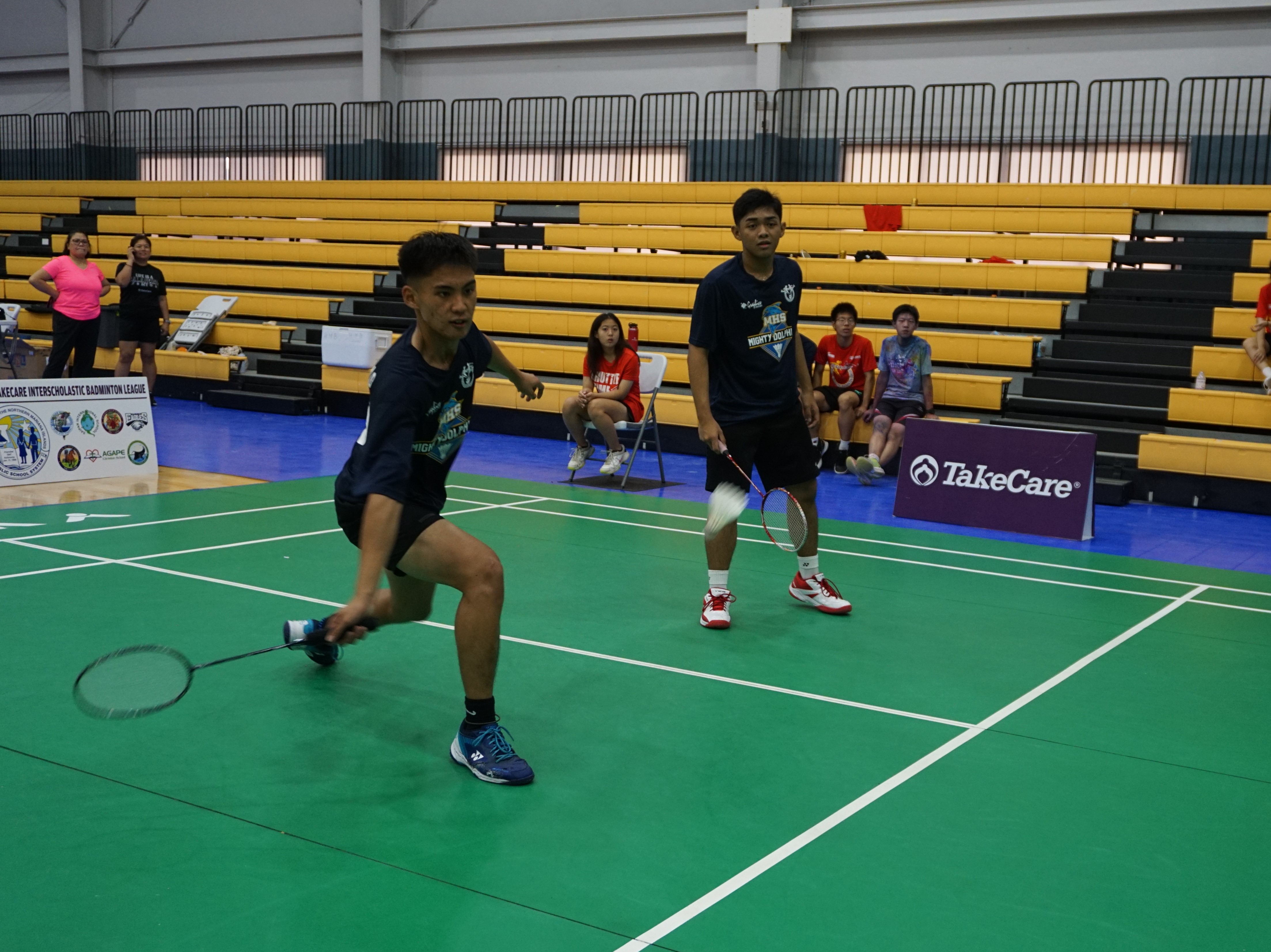 MHS 1's Ian Lubao extends for the swift return as teammate Kyle Selcado looks on during their match against ACS 1 in the boys doubles event of the TakeCare-PSS Interscholastic Badminton League championship at the Ada gym on Saturday.