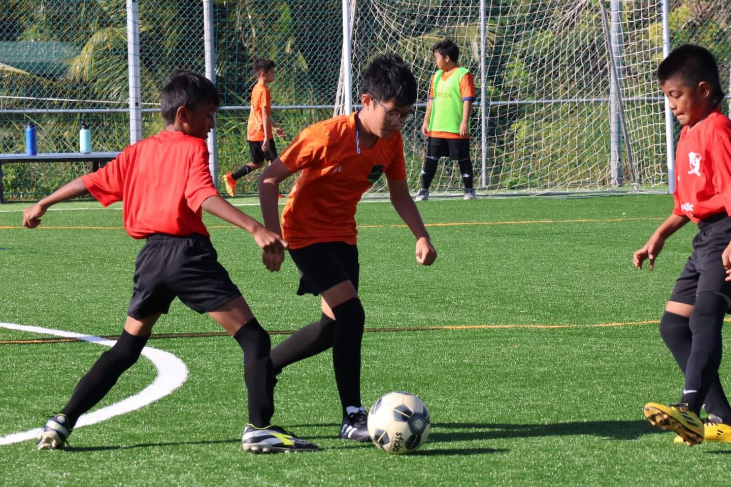A Kanoa 2 player dribbles past two Paire defenders during a U14 boys division game of the TakeCare Youth Soccer League at the NMI Soccer Training Center in Koblerville.
