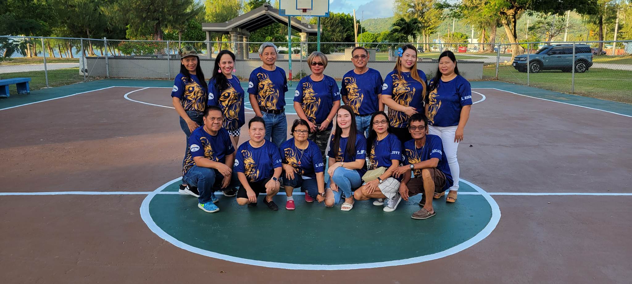 The Saipan Centennial Lions Club members pose for a photo at the newly repainted basketball court at the Civic Center in Susupe.