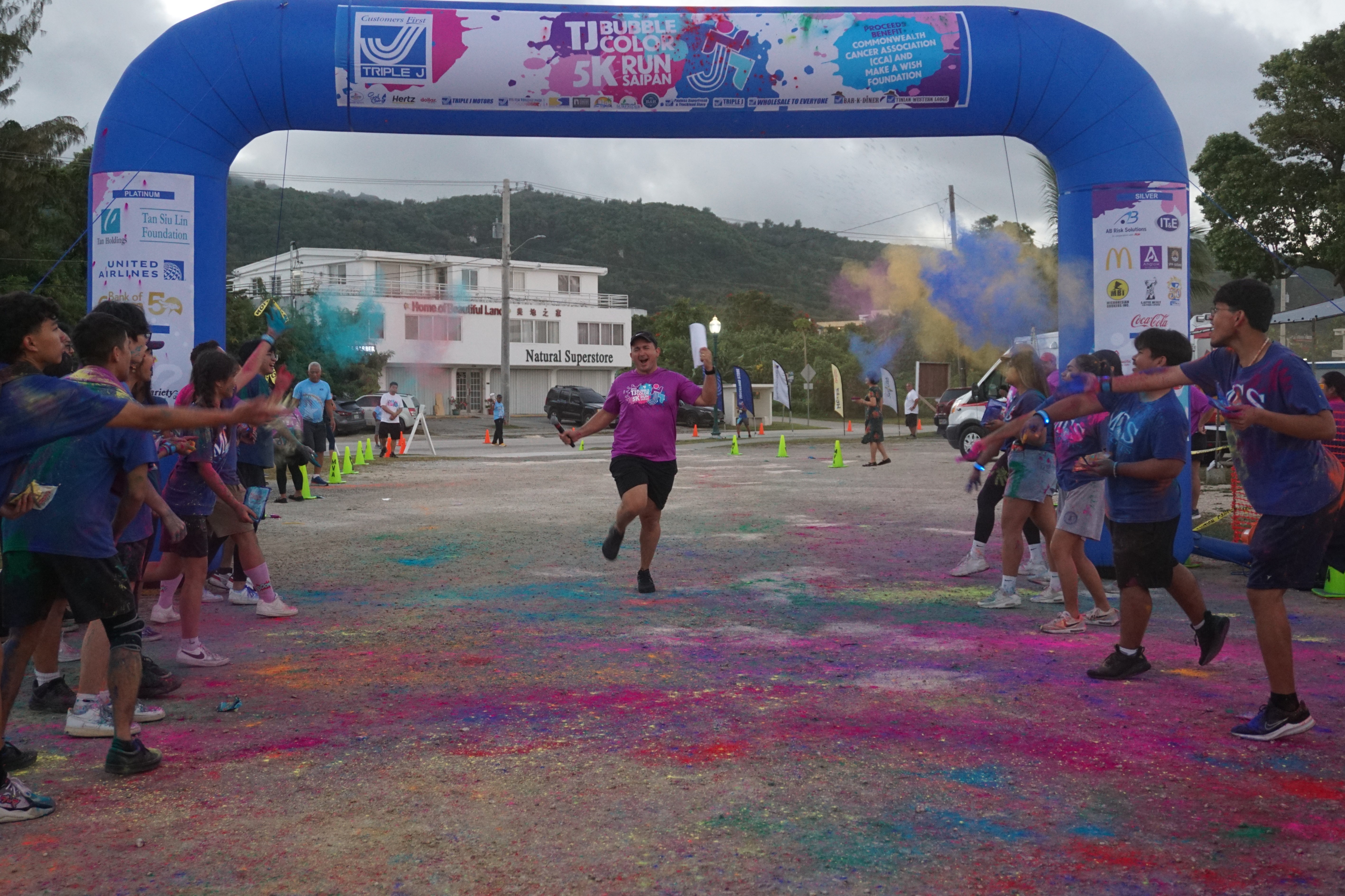 MC Brad Ruszala reacts as he is “welcomed” with color at the finish line.