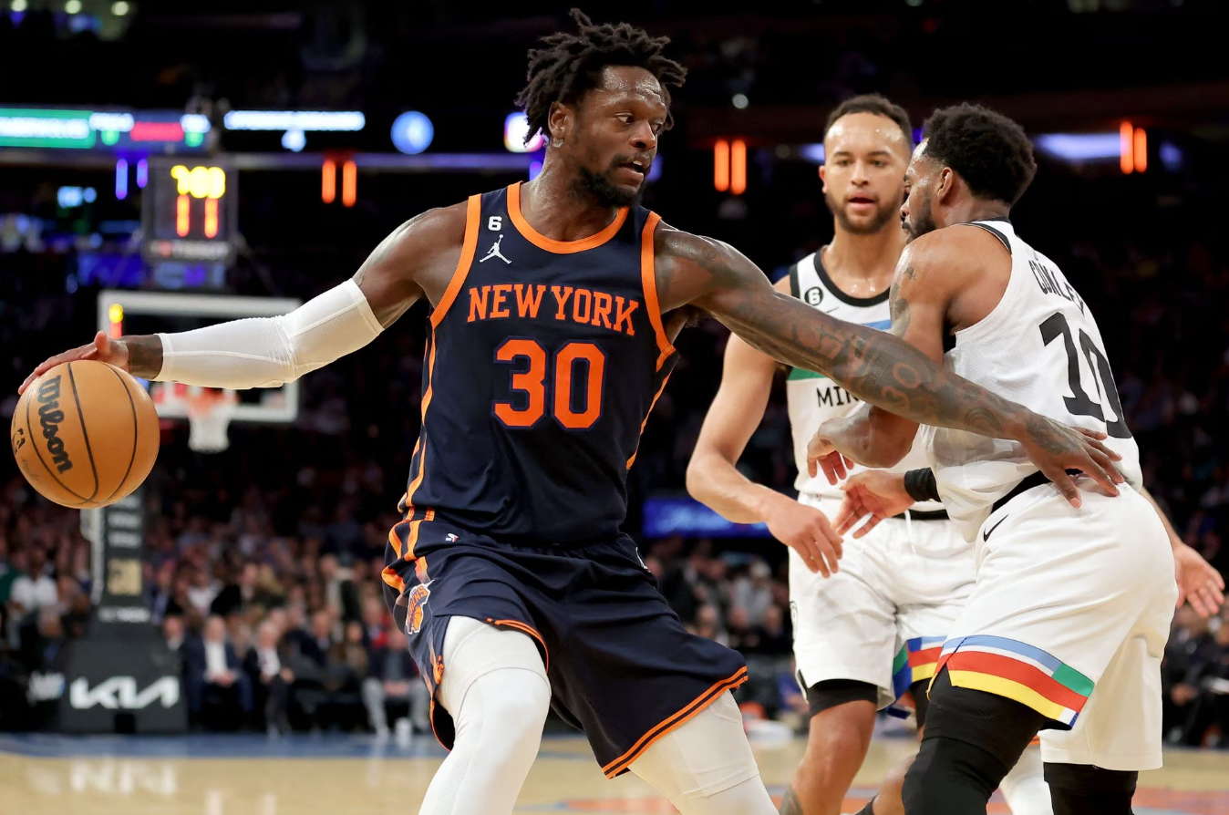 New York Knicks forward Julius Randle (30) controls the ball against Minnesota Timberwolves forward Kyle Anderson (5) and guard Mike Conley (10) during the third quarter at Madison Square Garden in New York, March 20, 2023.