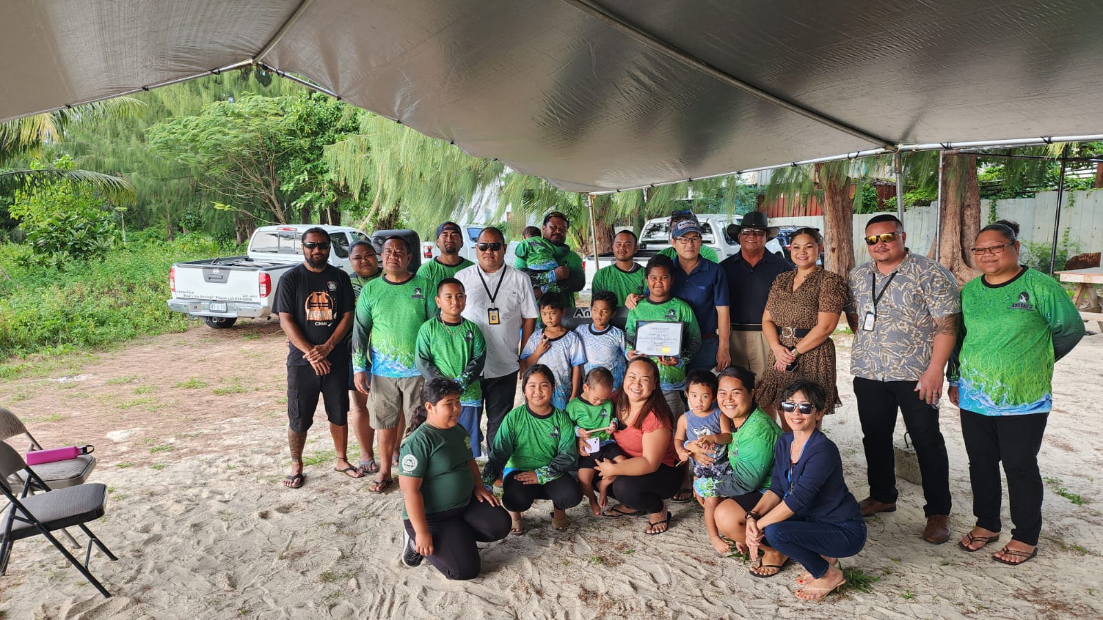 Saipan Mayor Ramon B. Camacho and lawmakers pose with the staff of Bwiibwii Professional Lawn Care Services and their family members during the adopt-a-place ceremony on Friday at Makaka Beach.