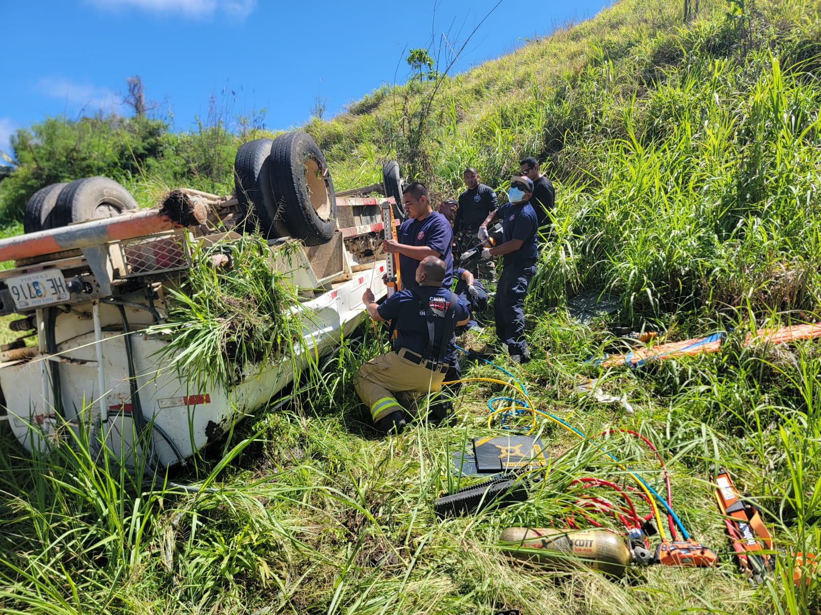 The fire department’s first responders use extraction and webbing tools to stabilize a water truck that overturned in Talofofo on Wednesday. The vehicle’s driver was safely pulled out and brought to the hospital where he was treated for minor injuries.